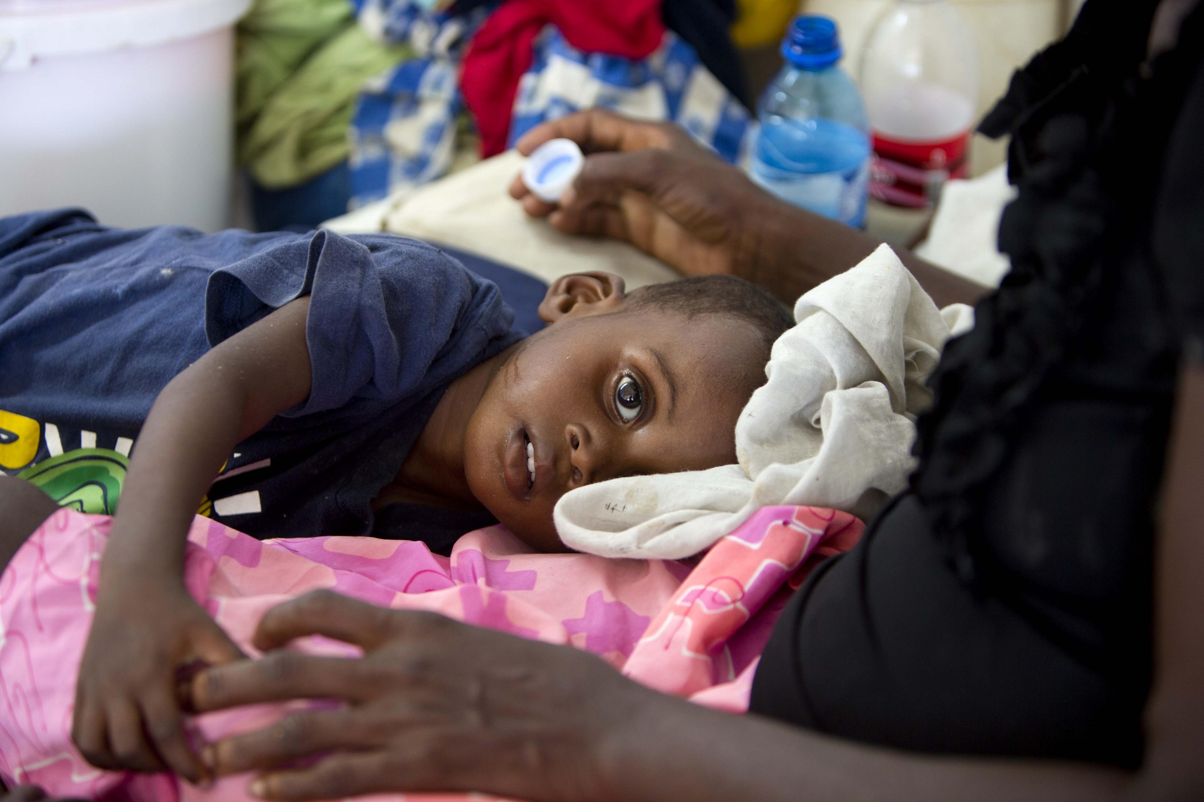 In this picture, a boy suffering from cholera receives treatment at a cholera centre in Anse D"Hainault, Haiti, on 11 October, 2016. The UN says Hurricane Matthew has increased the risk of a "renewed spike" in the cholera cases.