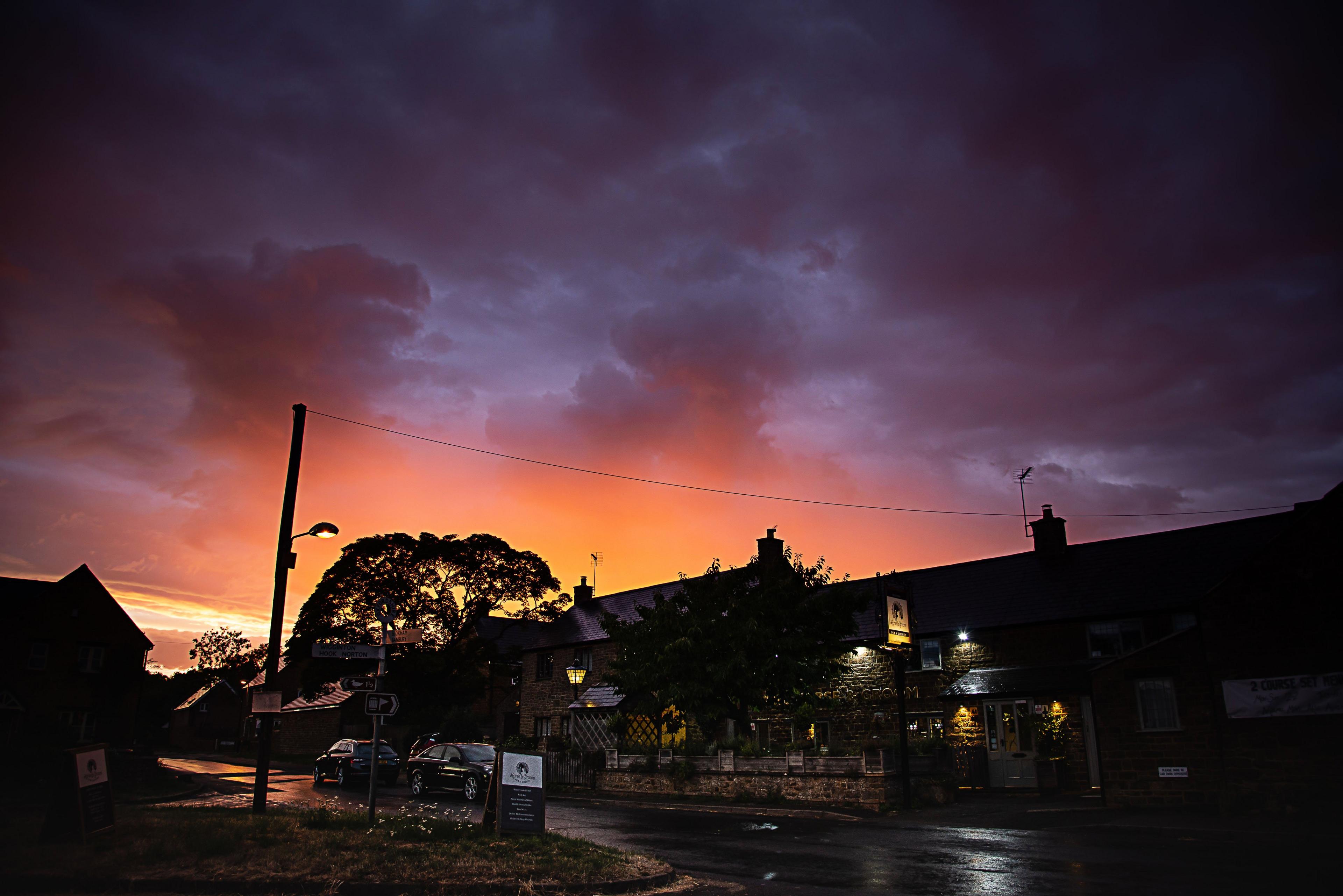 The sun setting over a pub in Milcombe