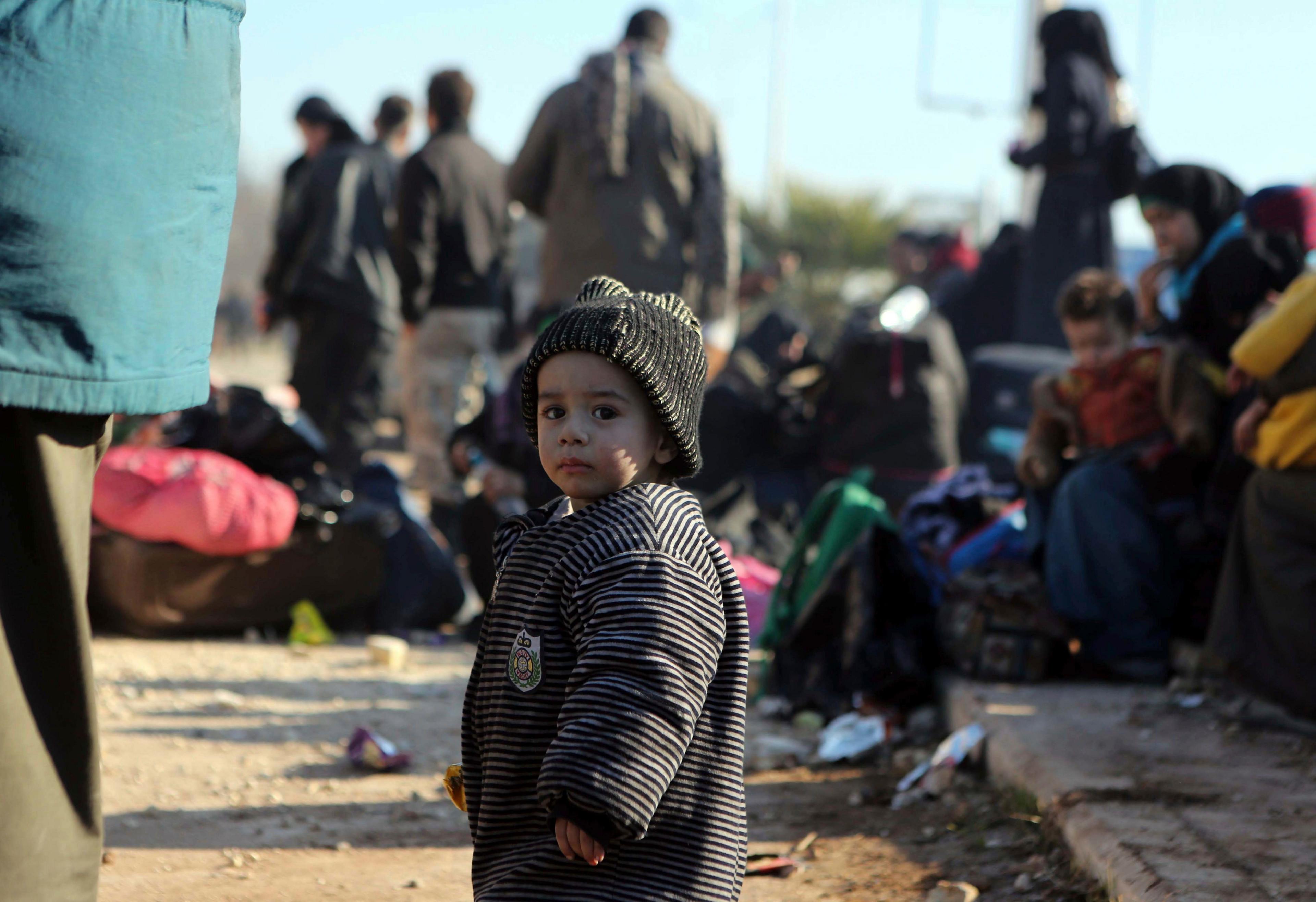 A young Syrian child evacuated from the embattled Syrian city of Aleppo during the ceasefire arrives at a refugee camp in Rashidin, near Idlib