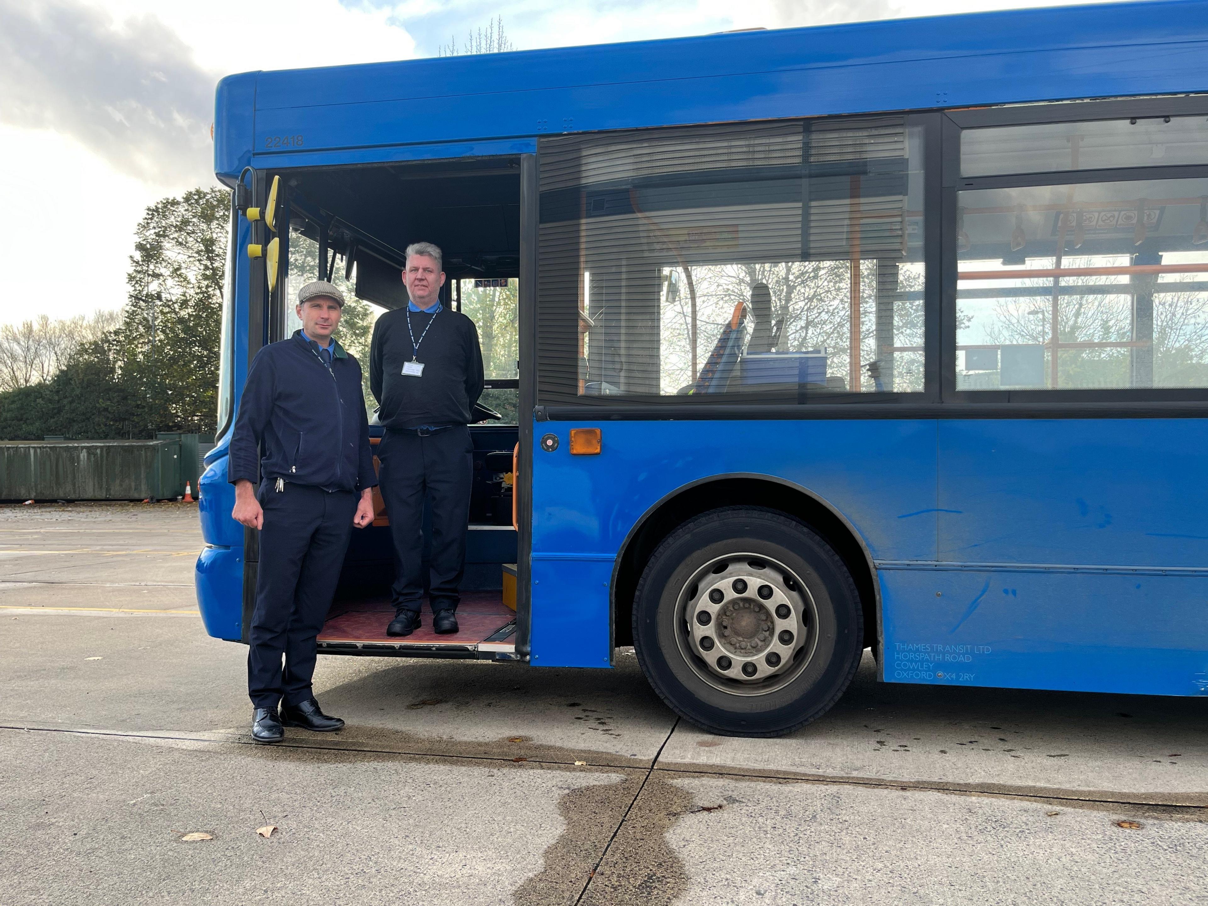 Trainee bus drivers Peter Kriel and Norman Opie standing beside a bus in Oxford.