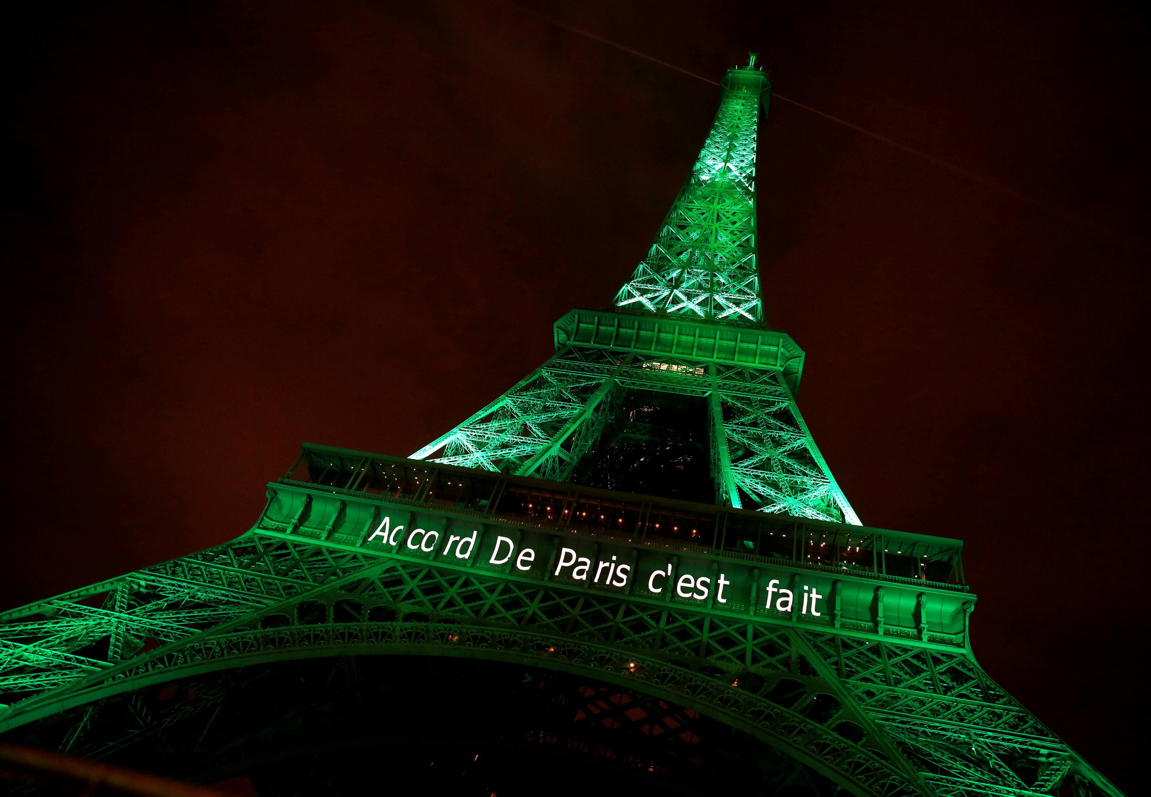 The Eiffel tower is illuminated in green with the words "Paris Agreement is Done", to celebrate the Paris U.N. COP21 Climate Change agreement