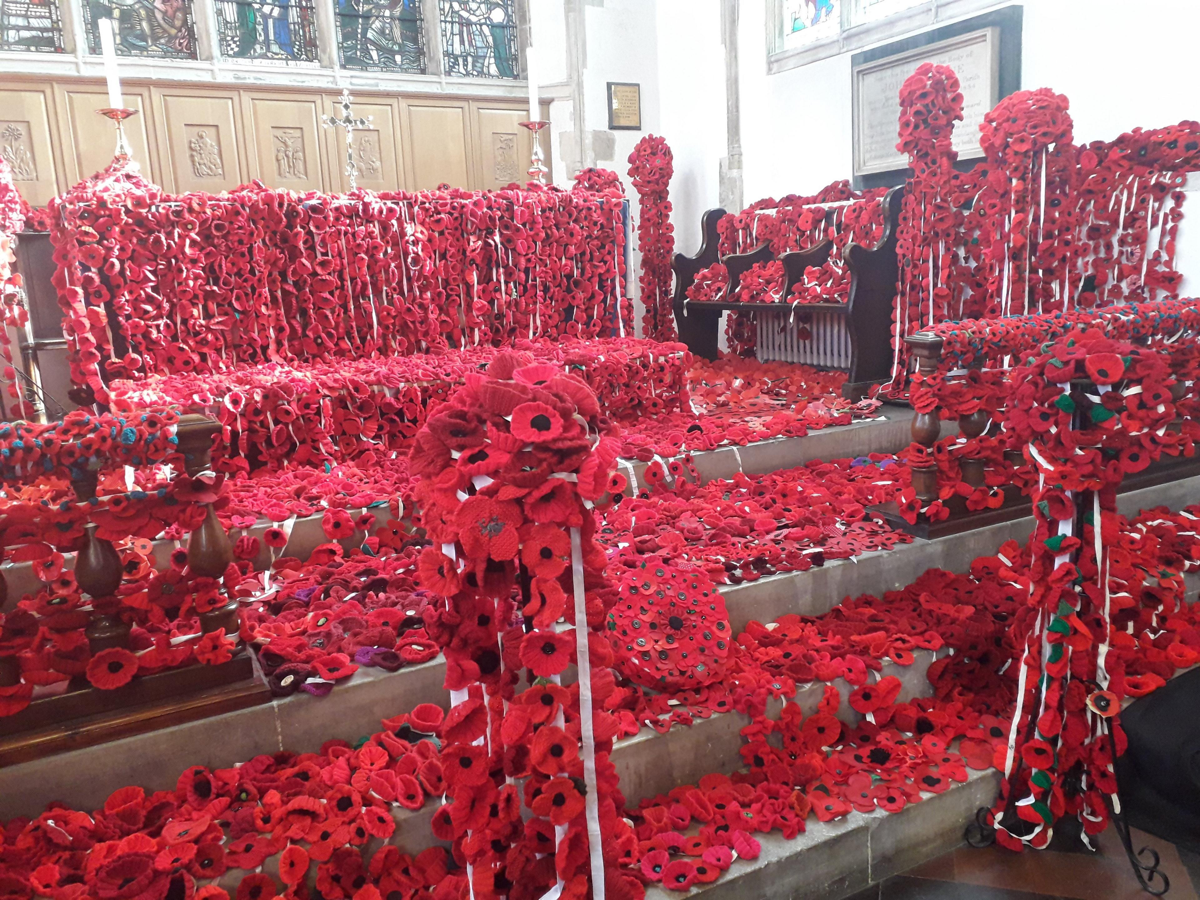 Thousands of fabric poppies on display on a church altar