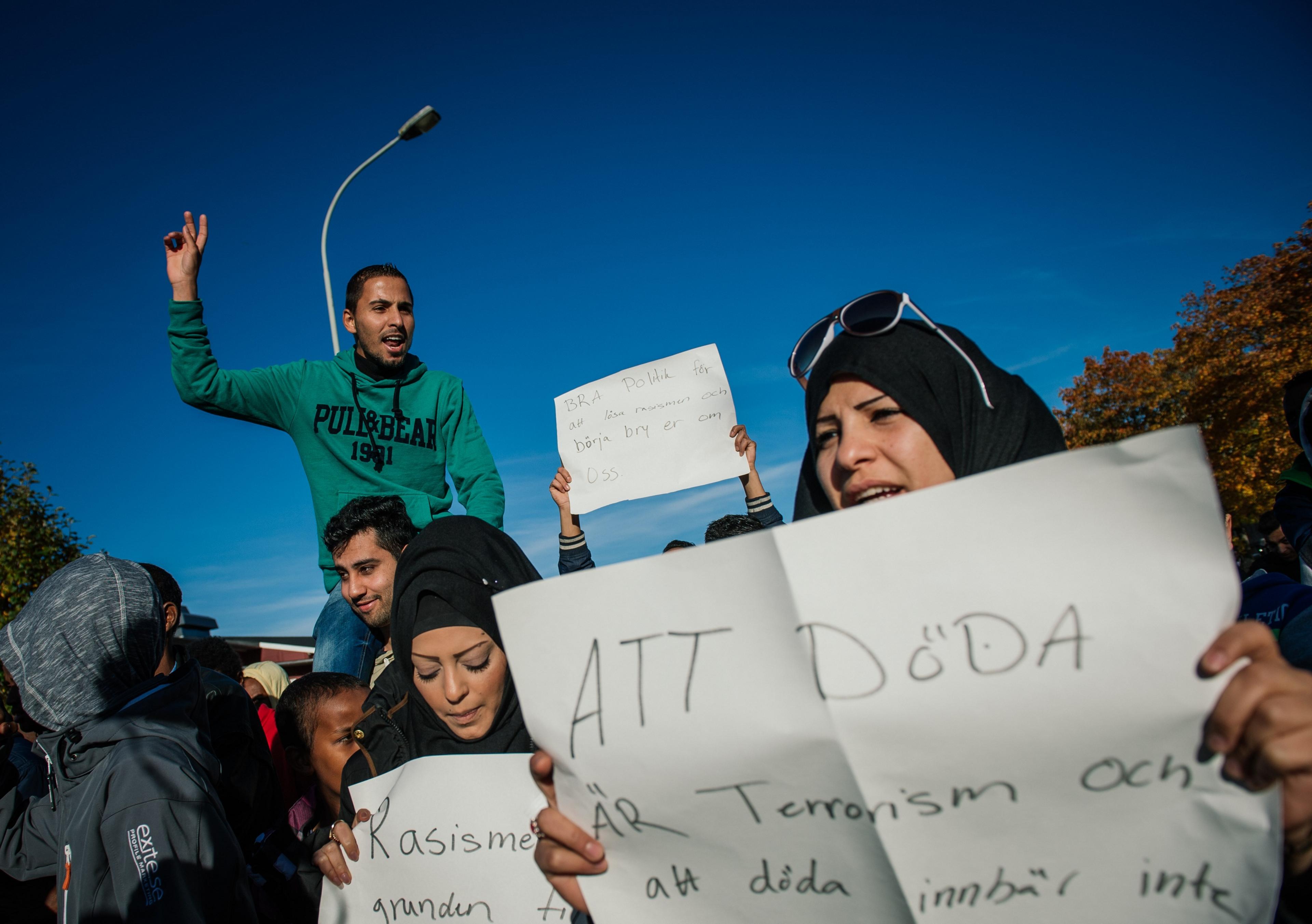 People gather to demonstrate while shouting "No to racism" and "Protect our children" outside the primary and middle school Kronan in Trollhattan