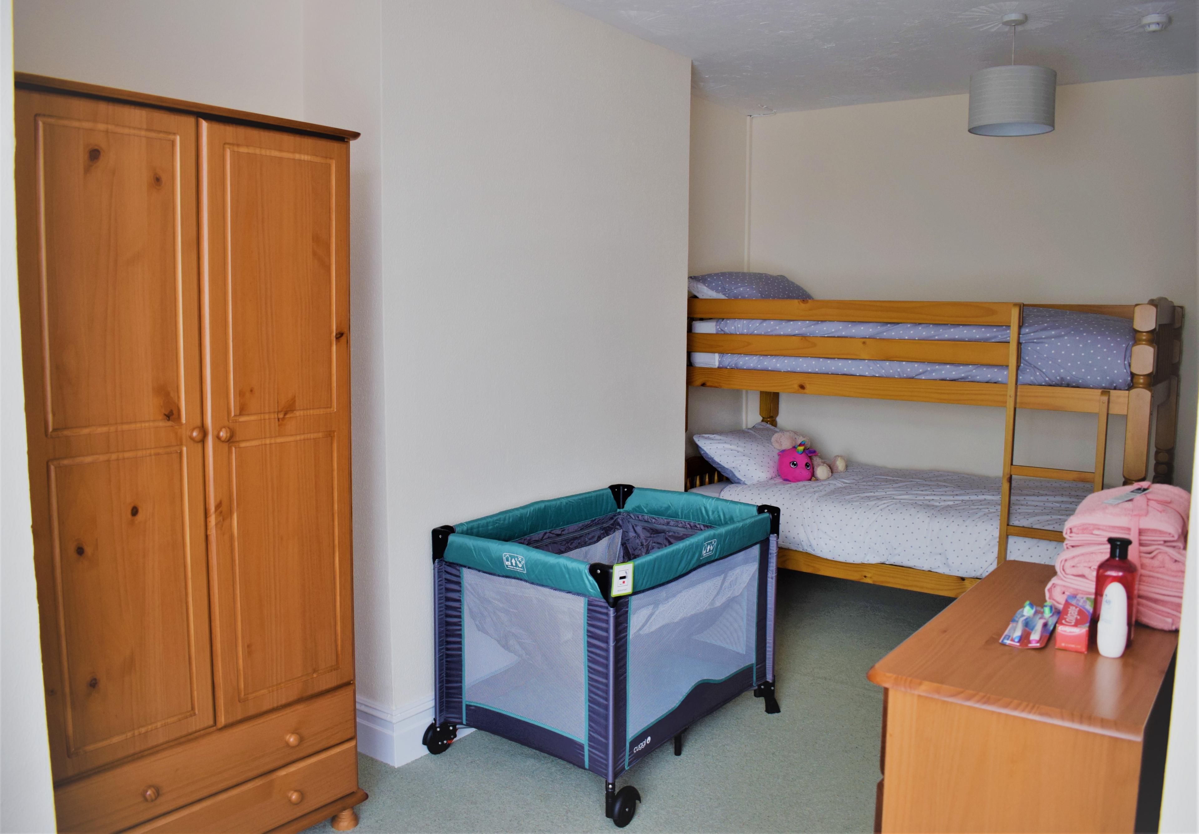 A cot and bunk beds at a refuge space