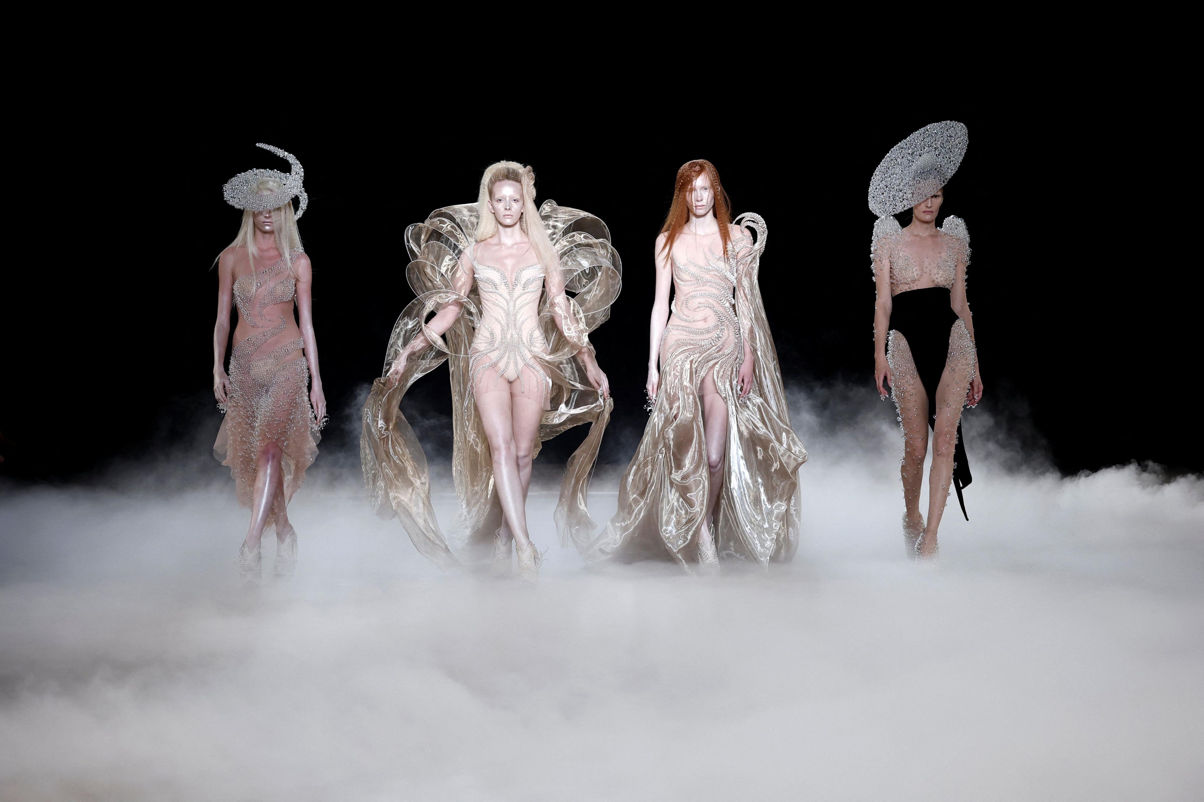 Models present creations by designer Iris van Herpen as part of her Haute Couture Fall/Winter 2026-2027 collection show in Paris, France, July 6, 2026.