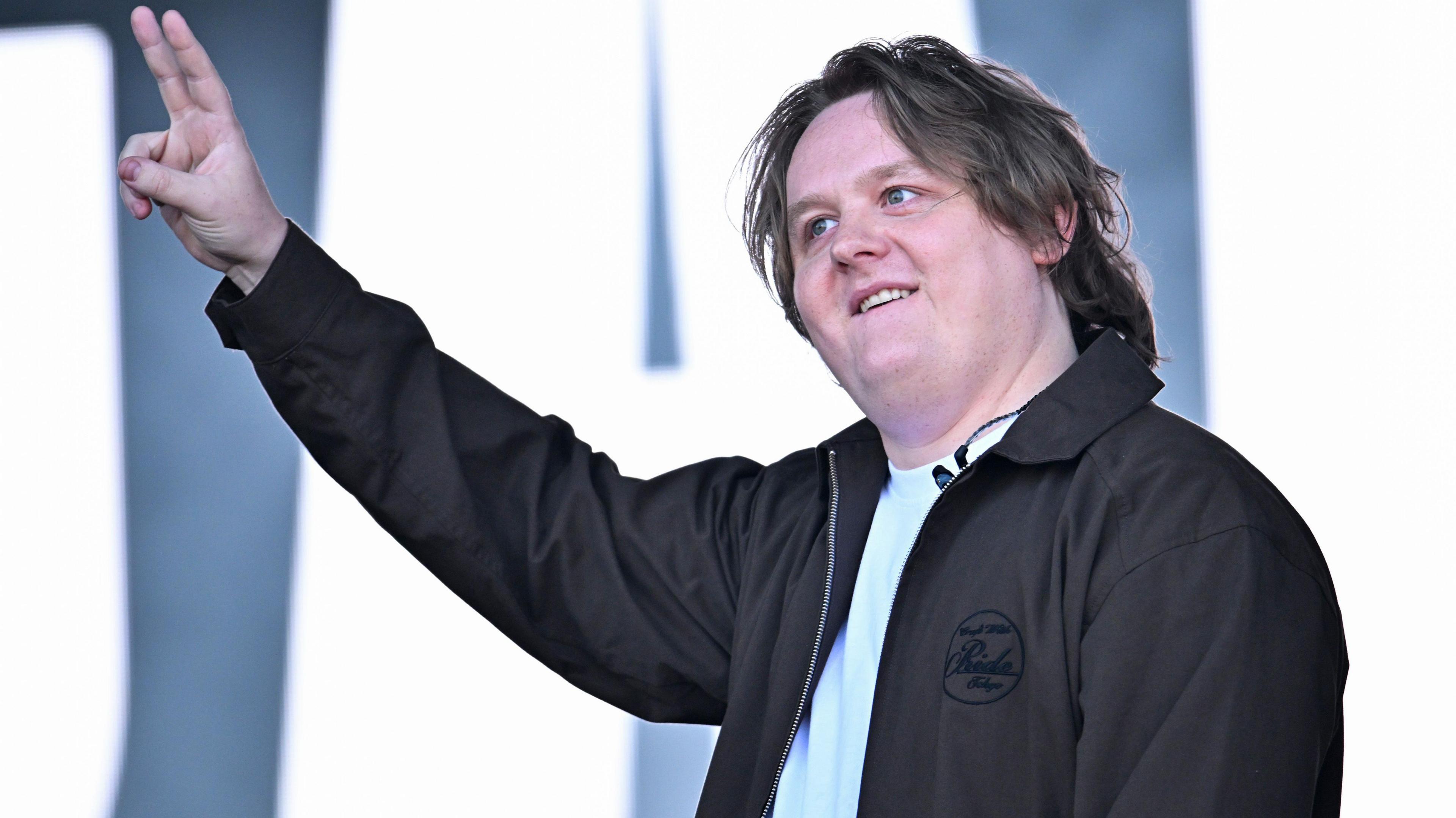 Lewis Capaldi gives the peace sign on stage at Glastonbury