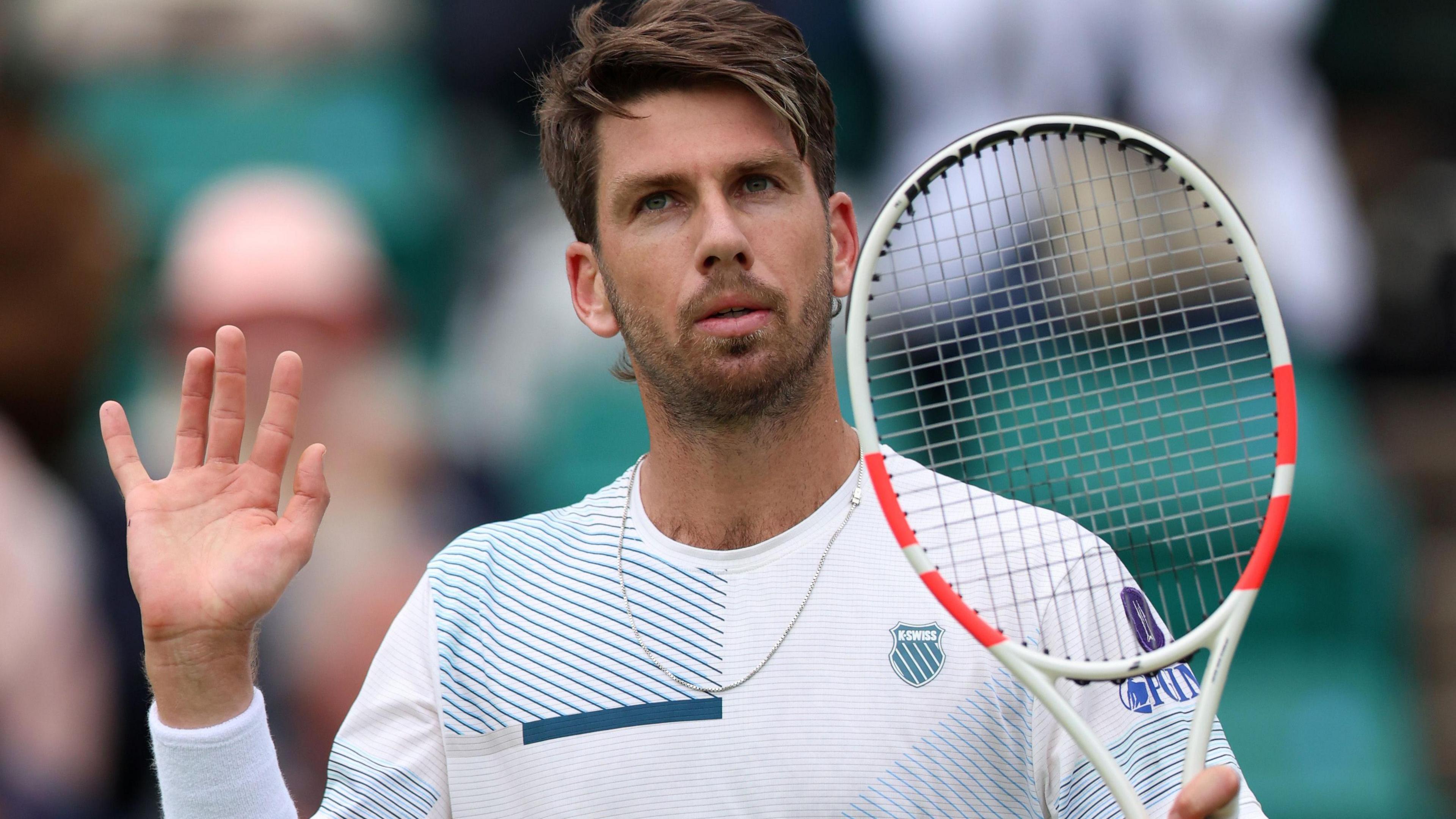 Cameron Norrie waves to supporters