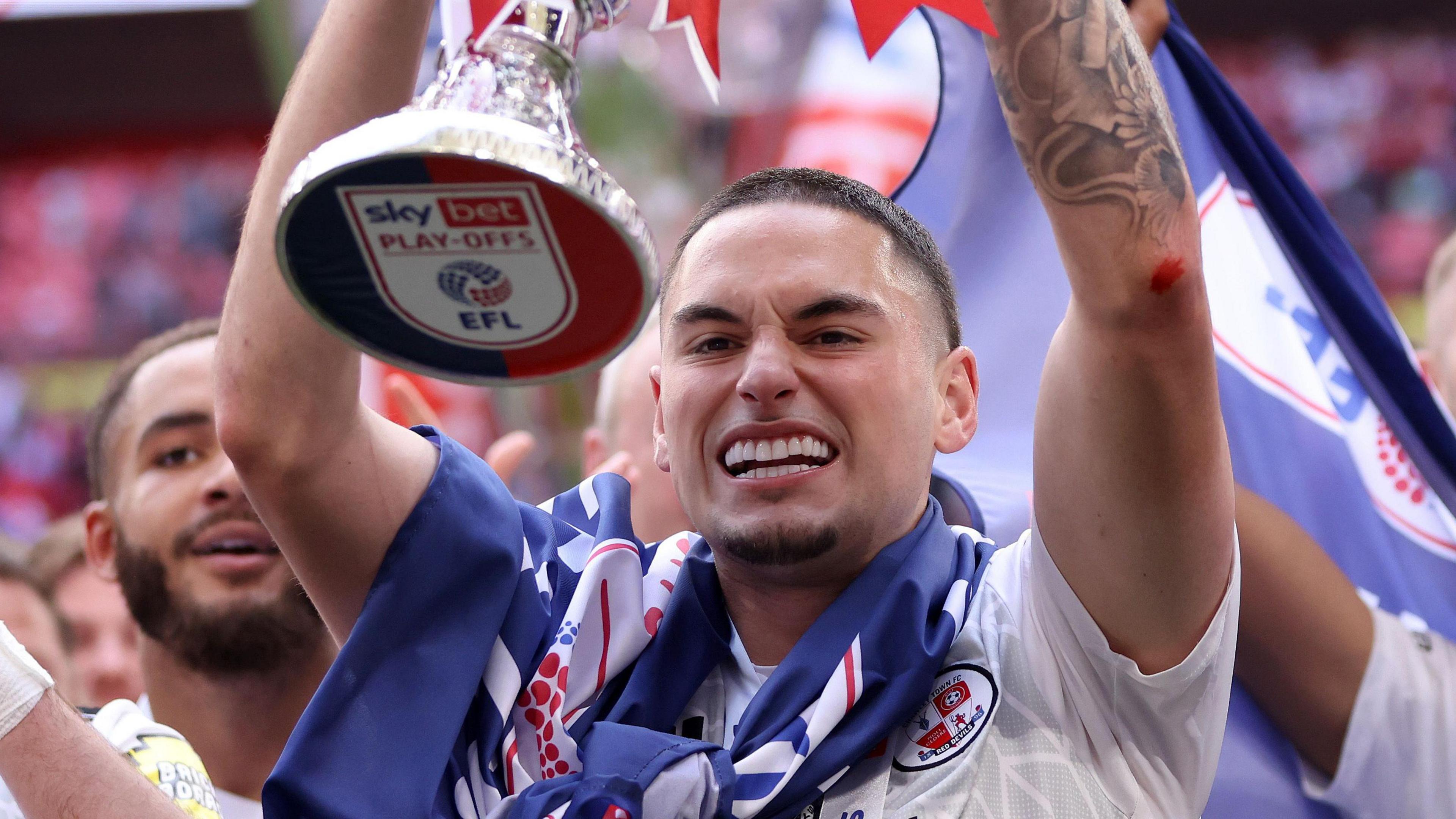 Klaidi Lolos at Wembley lifting the play off final trophy.