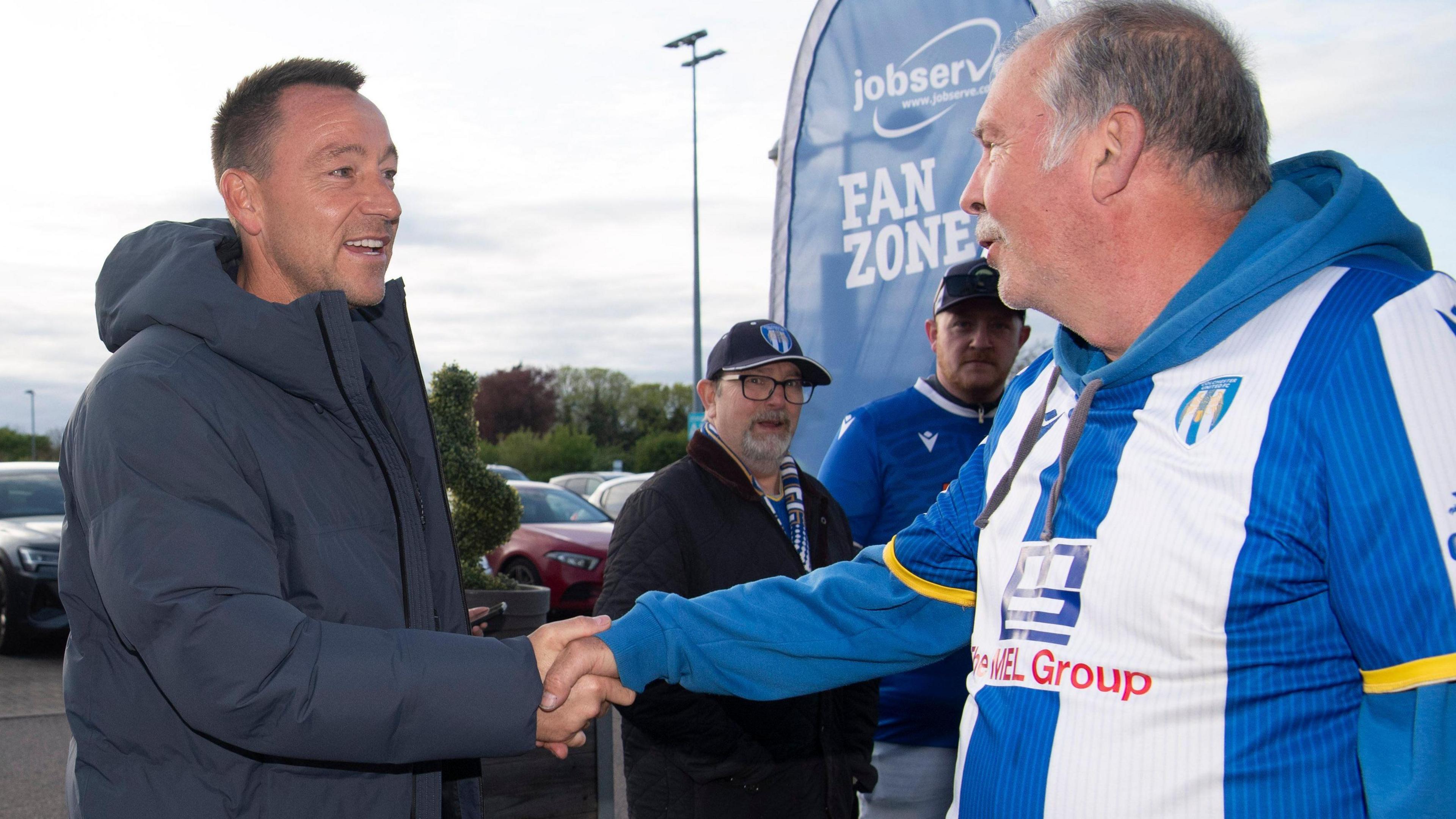 John Terry shakes the hand of a Colchester fan