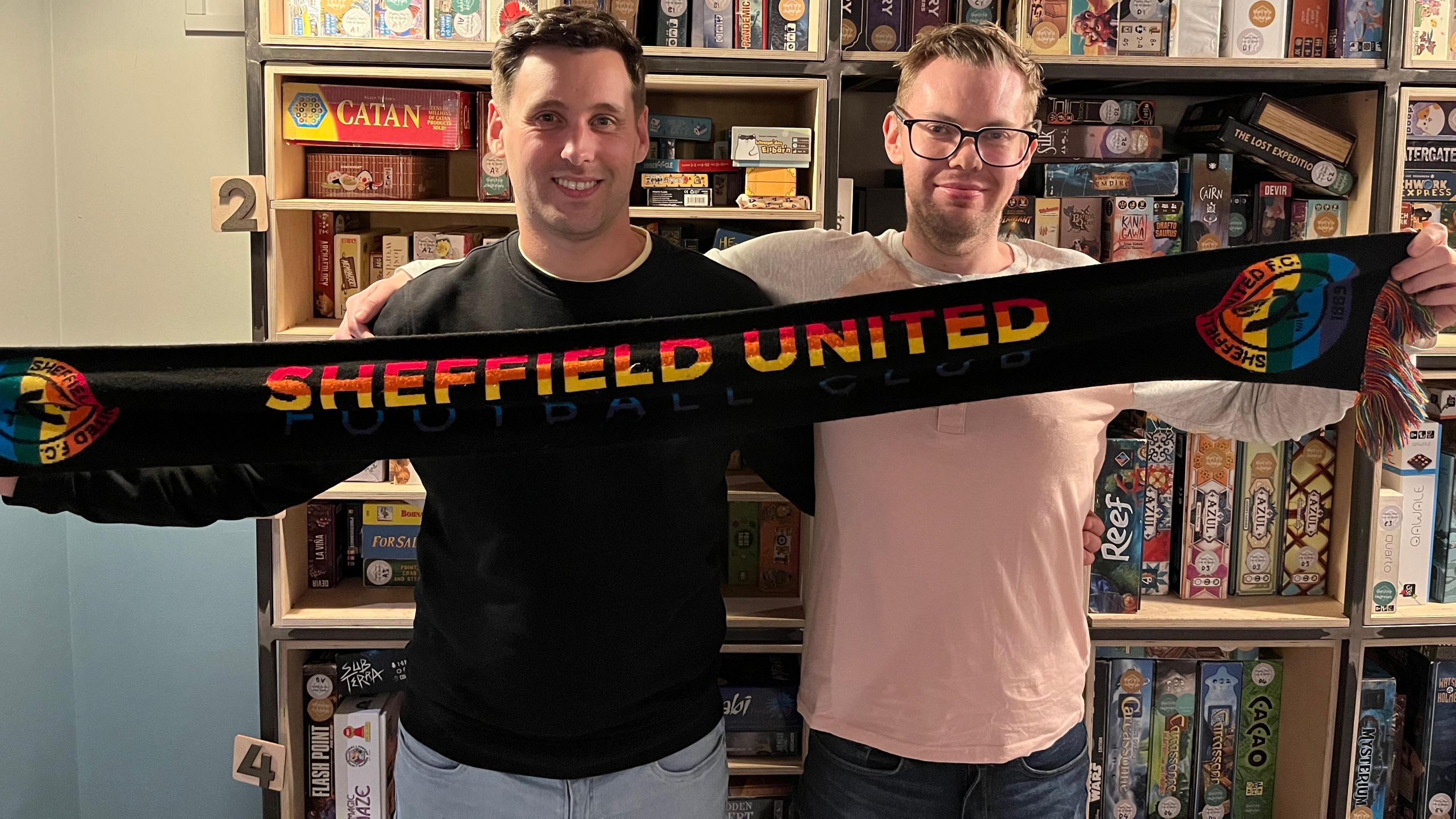 Rainbow Blades founder and Rainbow Owls chair Chris Ledger pictured holding a Sheffield United rainbow scarf