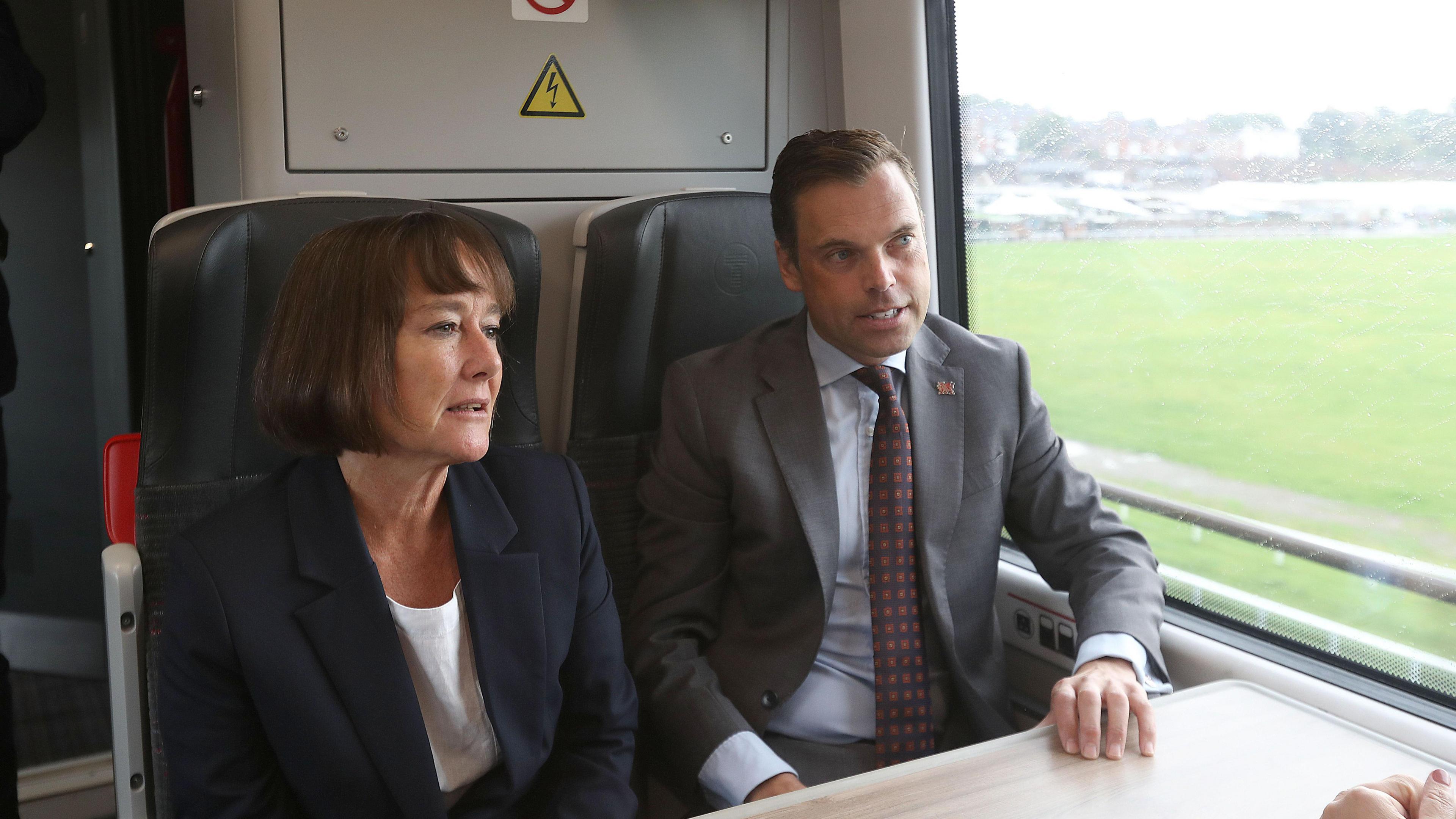 Jo Stevens and Ken Skates sitting alongside each other on a train on Wednesday