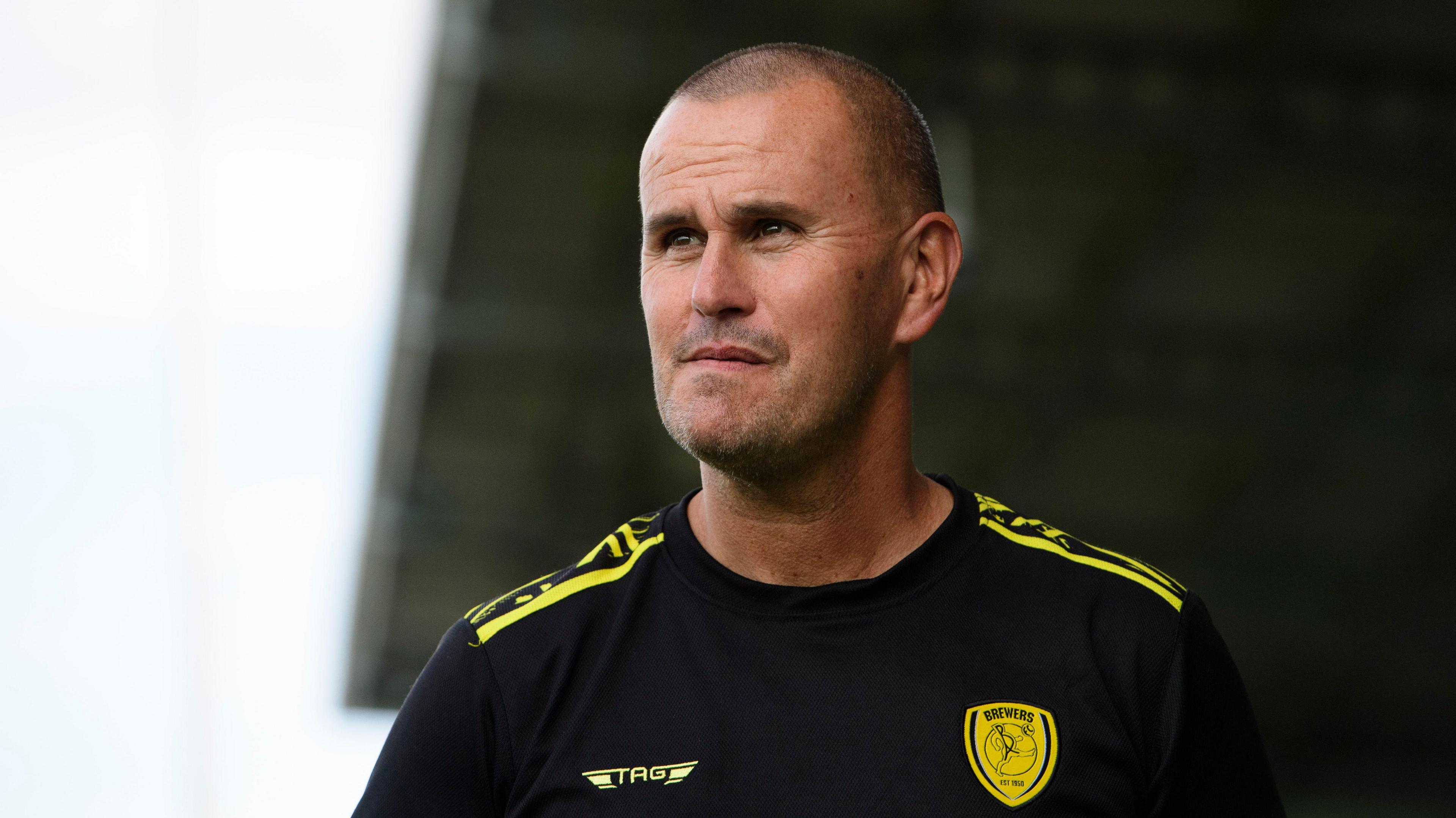 Burton boss Mark Robinson watches his side from the side of the pitch