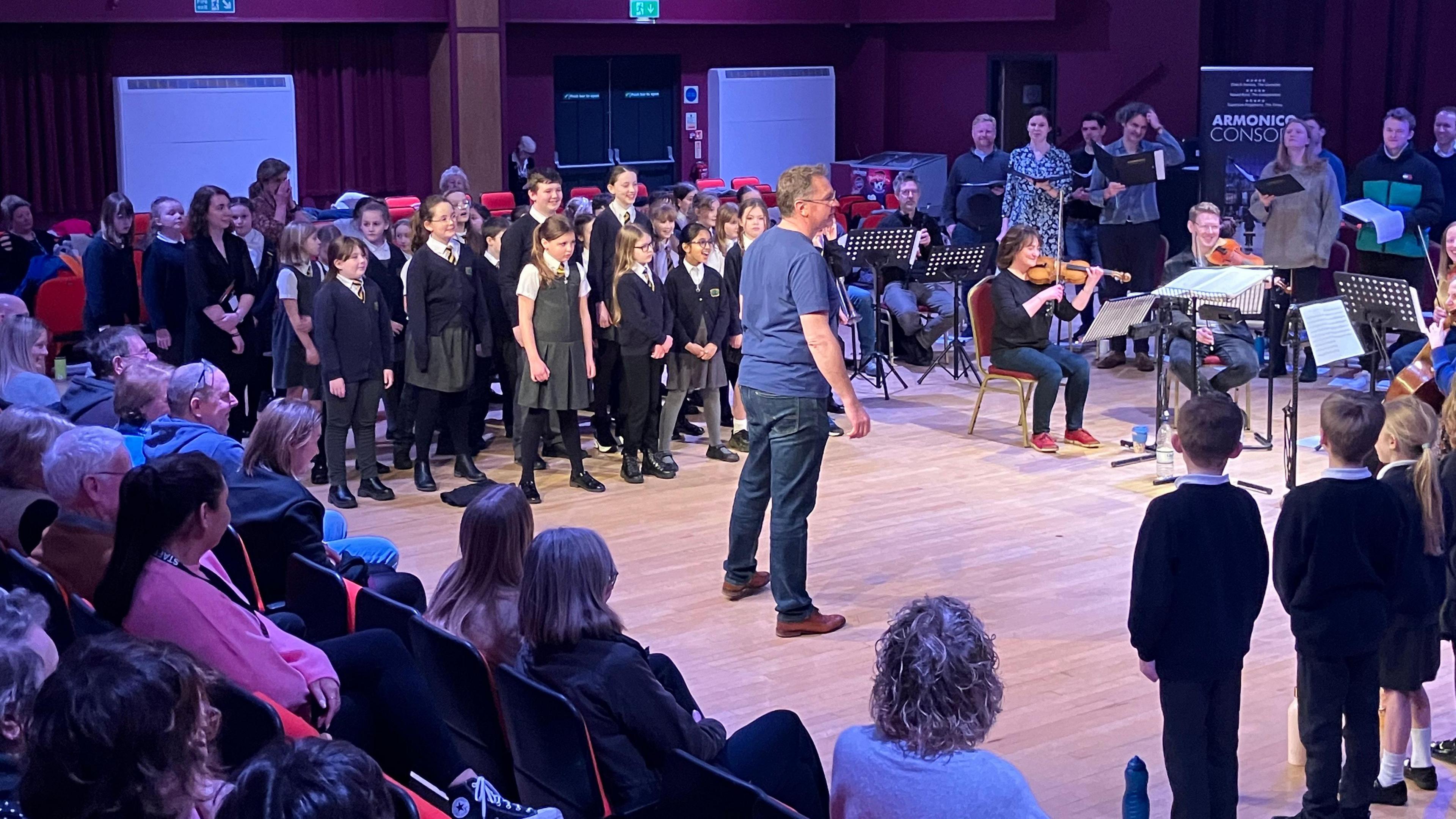 School children and musicians performing for their parents