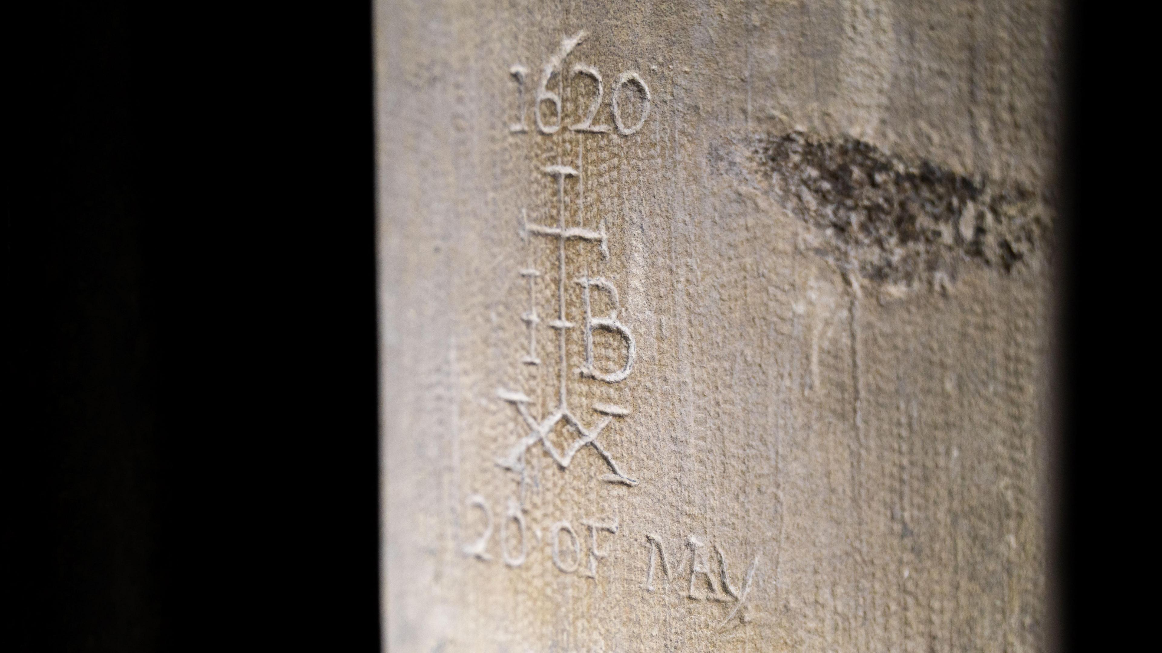 Historic graffiti showing a cross with the date '1620' above it, the letters I and B to the sides, a double xx below and the date '20 of May'.