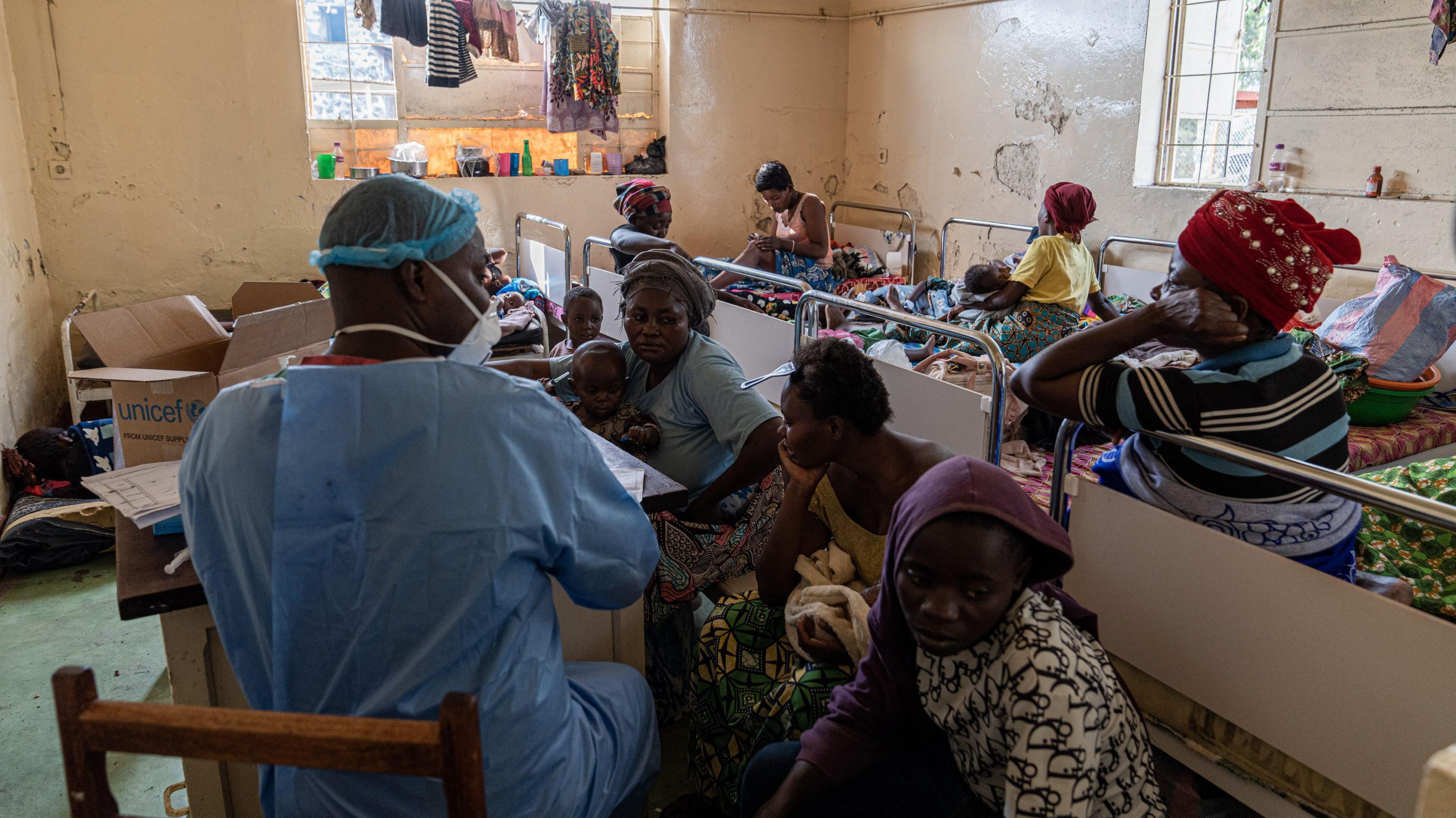 Women and children sit waiting to see a doctor