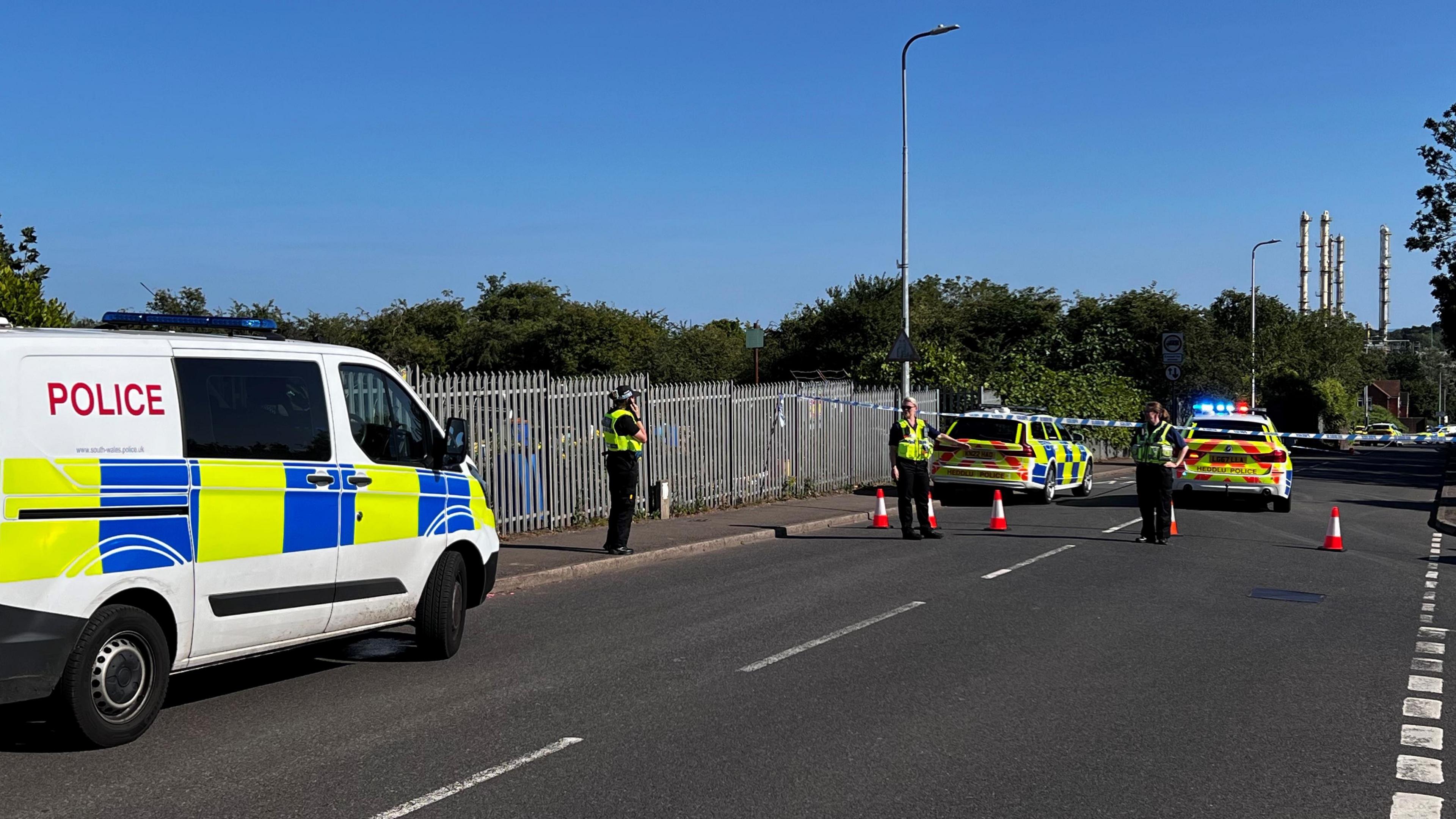 police vehicles, officers and cordon