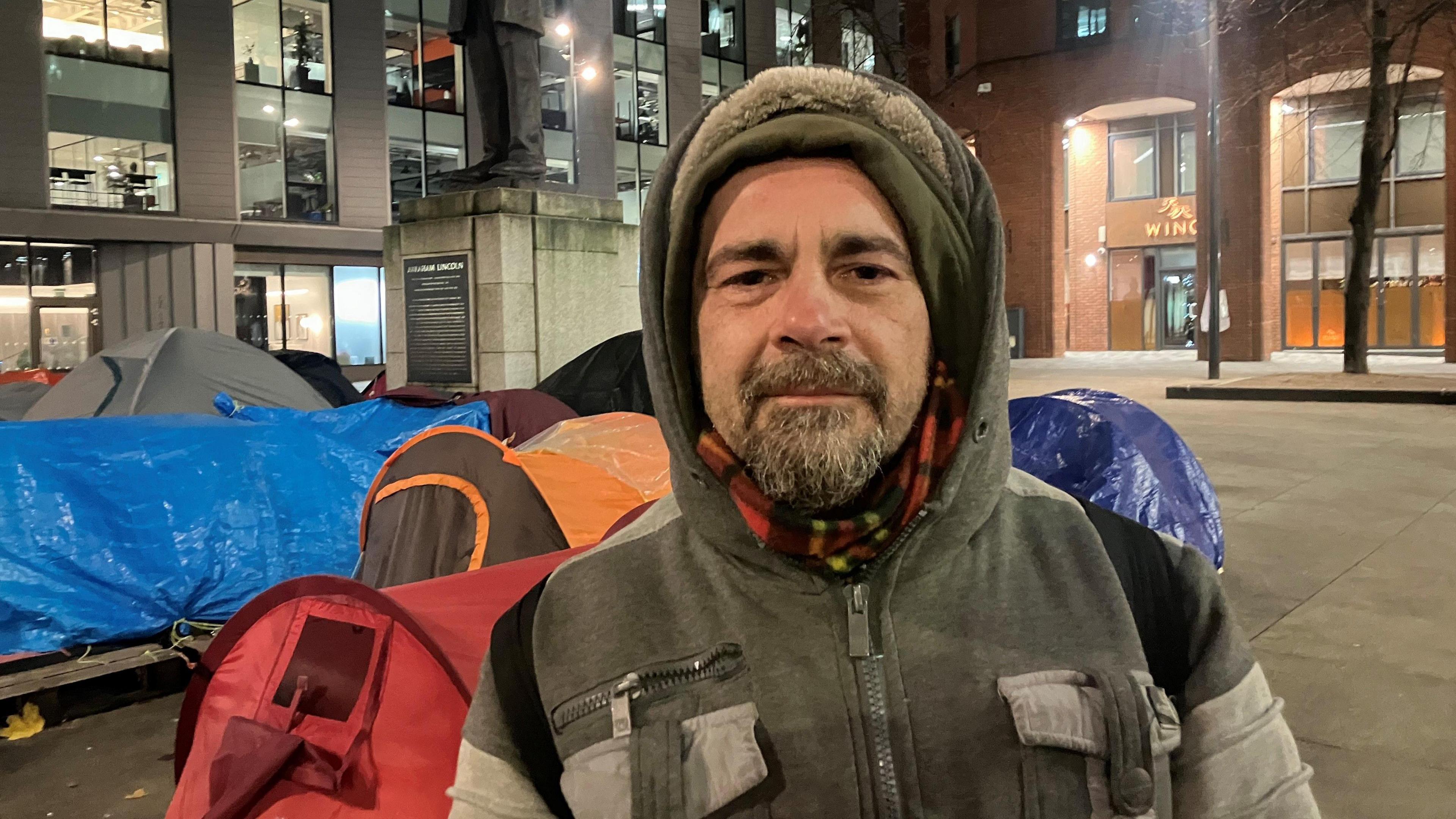 Photograph of Ivan Dario from Italy, who has been living in a tent in Manchester city centre. He is pictured in Lincoln Square.