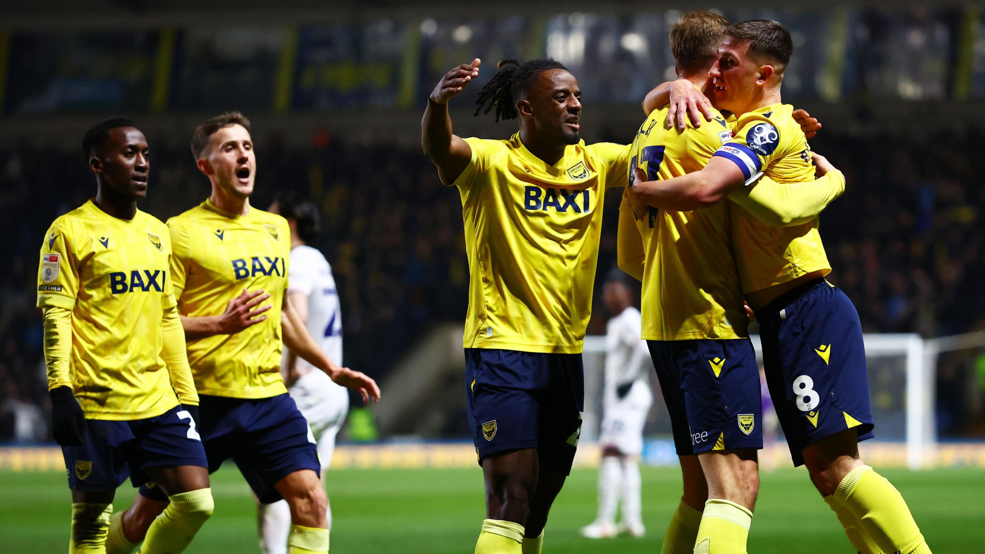 Oxford United players celebrating Michal Helik's goal against Luton Town