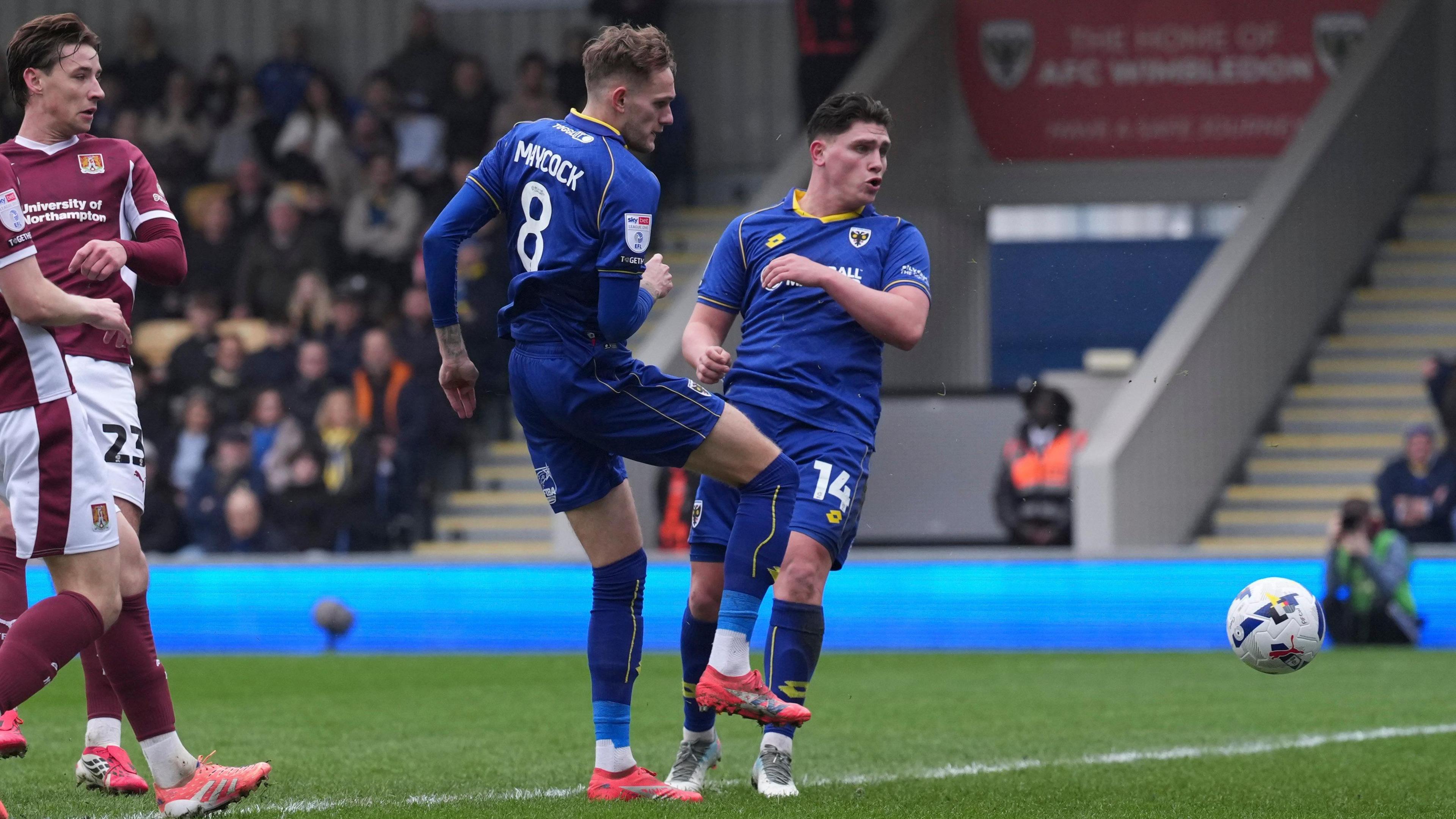 Callum Maycock and Matty Stevens watch the football after Maycock takes a shot