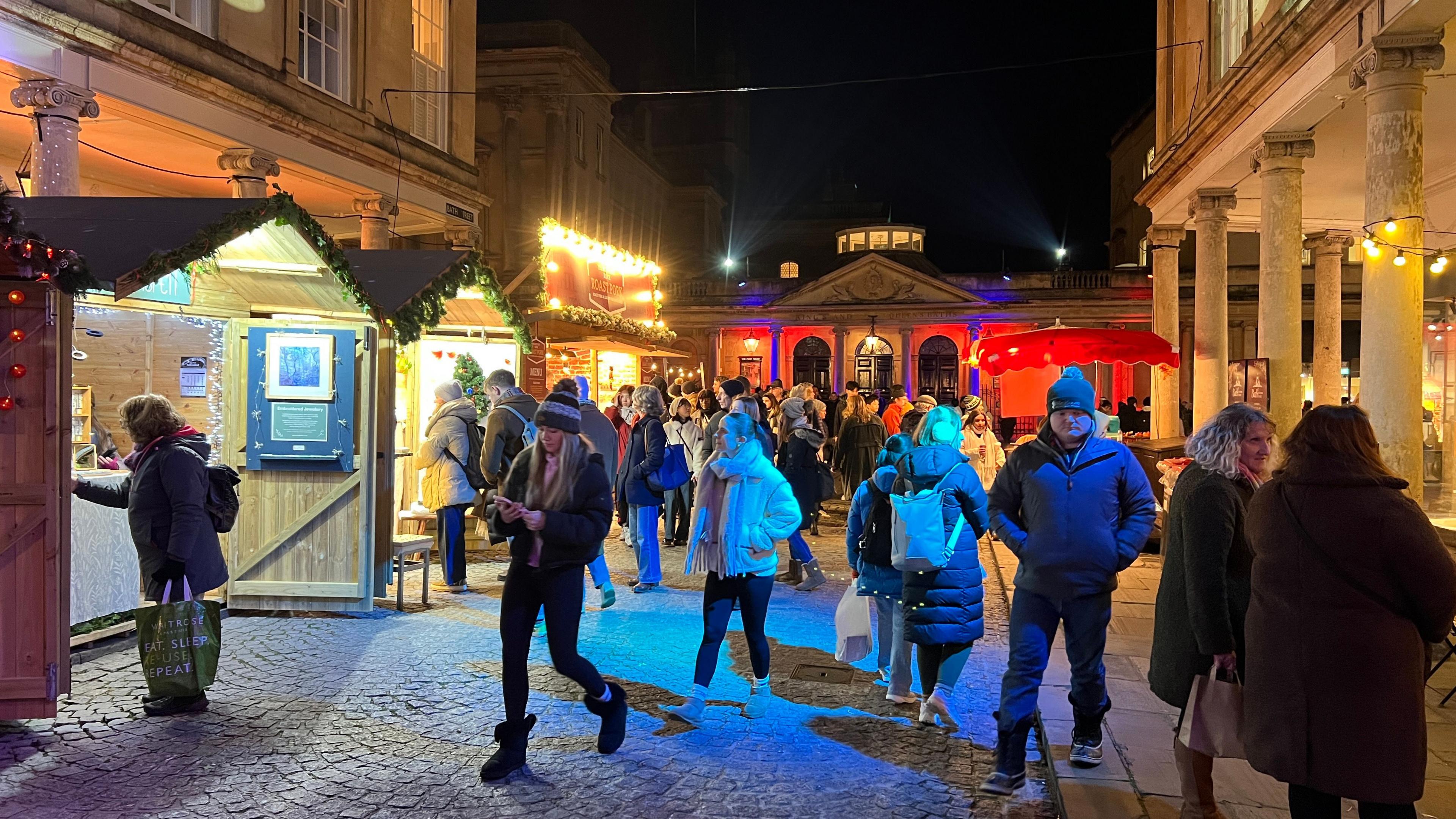 People milling about at the Bath Christmas Market pictured during the night