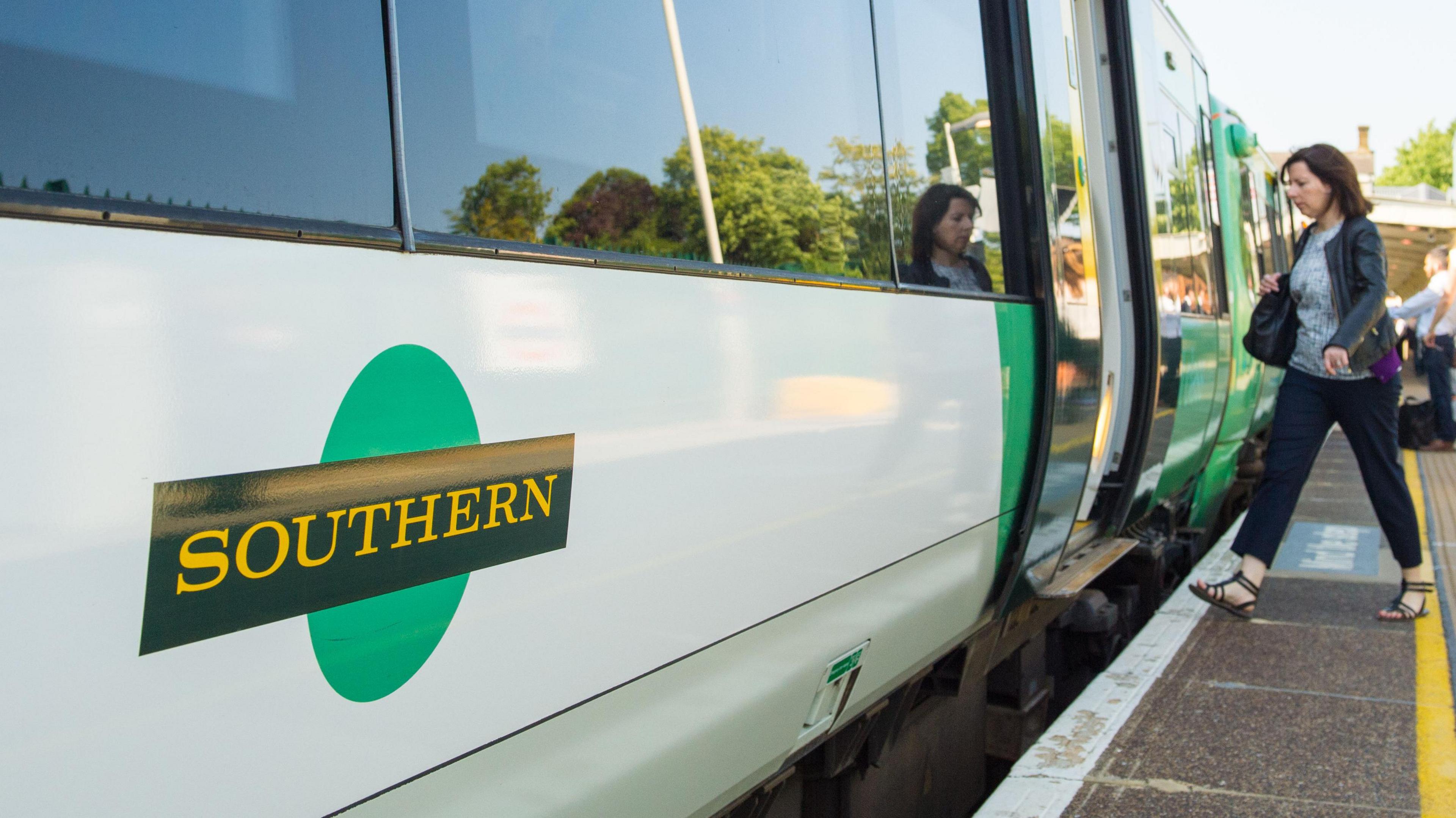 A close up of the side of a Southern Rail train