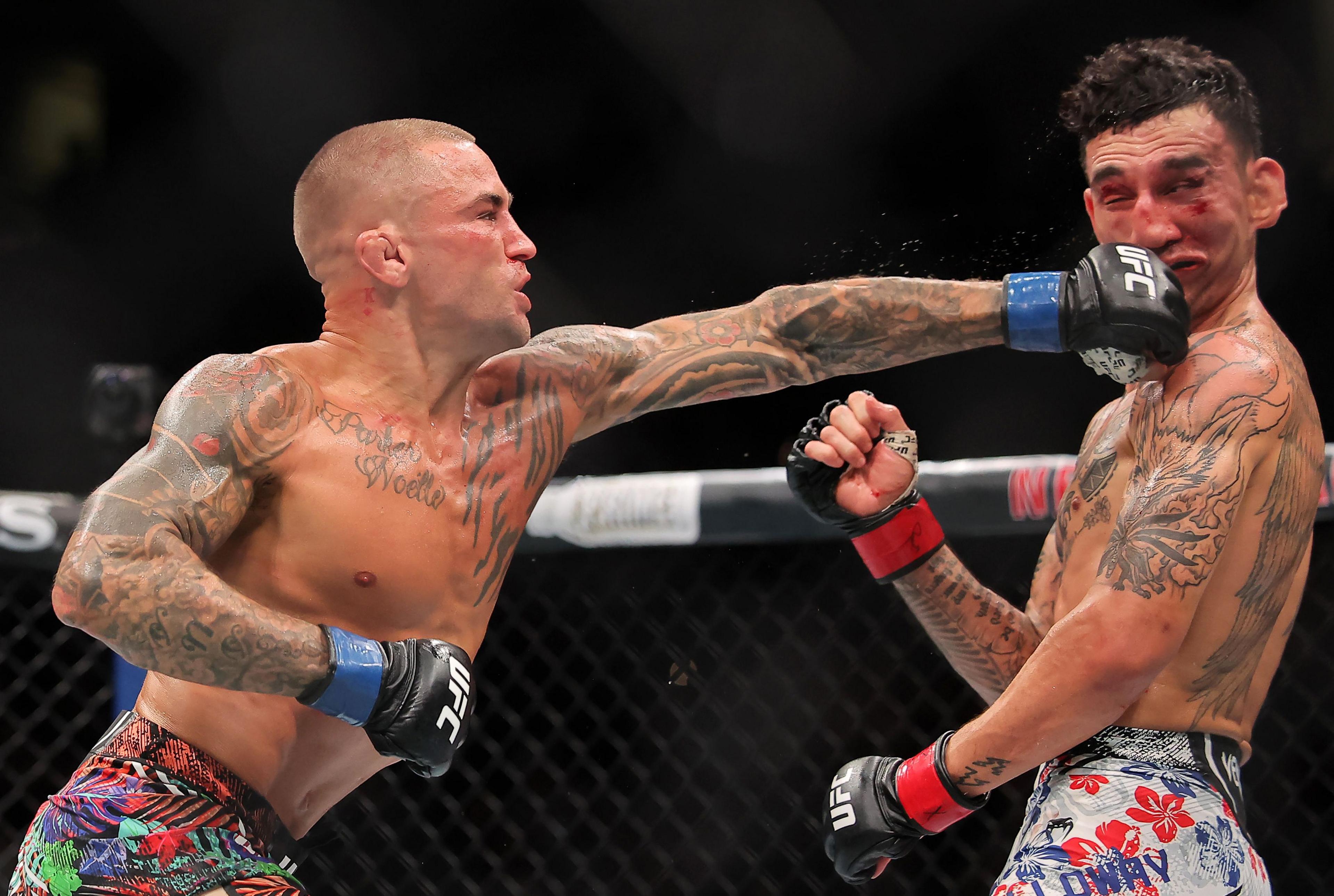Dustin Poirier strikes Max Holloway during their lightweight bout during UFC 318. Photo by Jonathan Bachman
