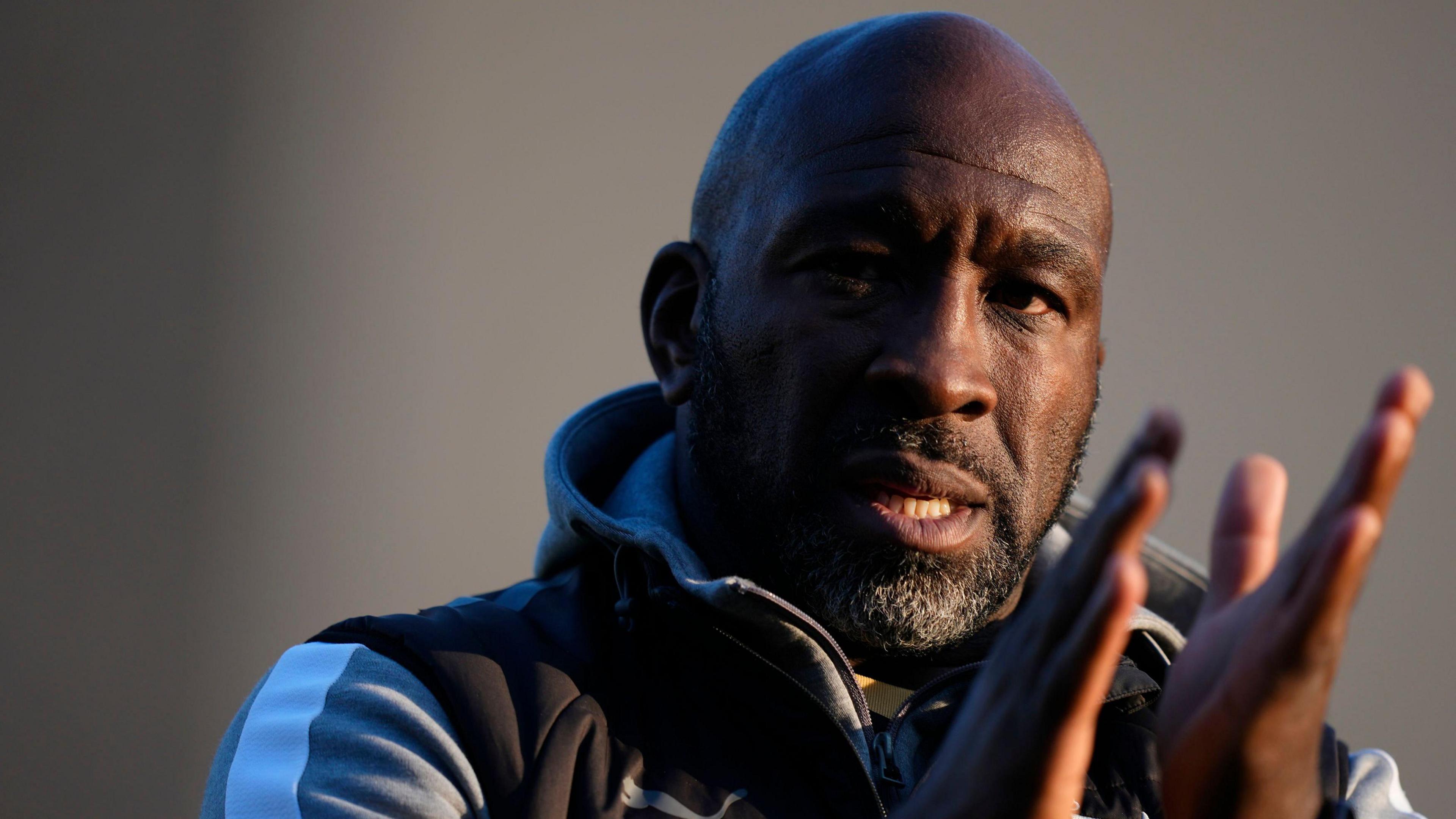 Port Vale boss Darren Moore claps the crowd at the end of a game