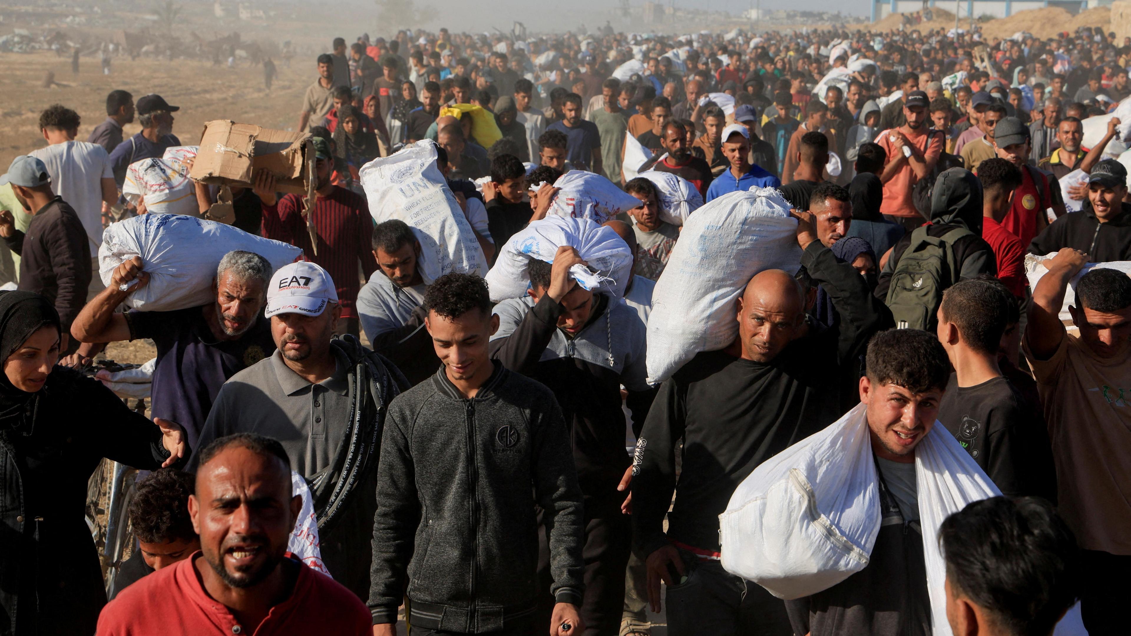 Palestinians carry aid supplies from the U.S.-backed Gaza Humanitarian Foundation, in Khan Younis.