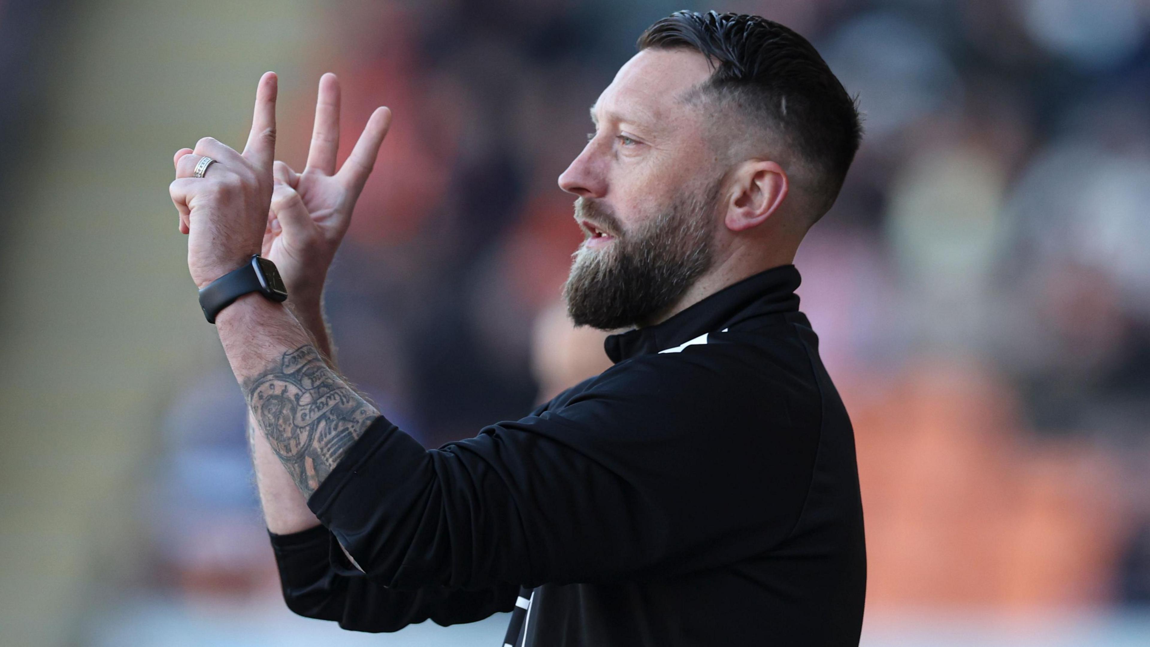 Stephen Dobbie holding up three fingers