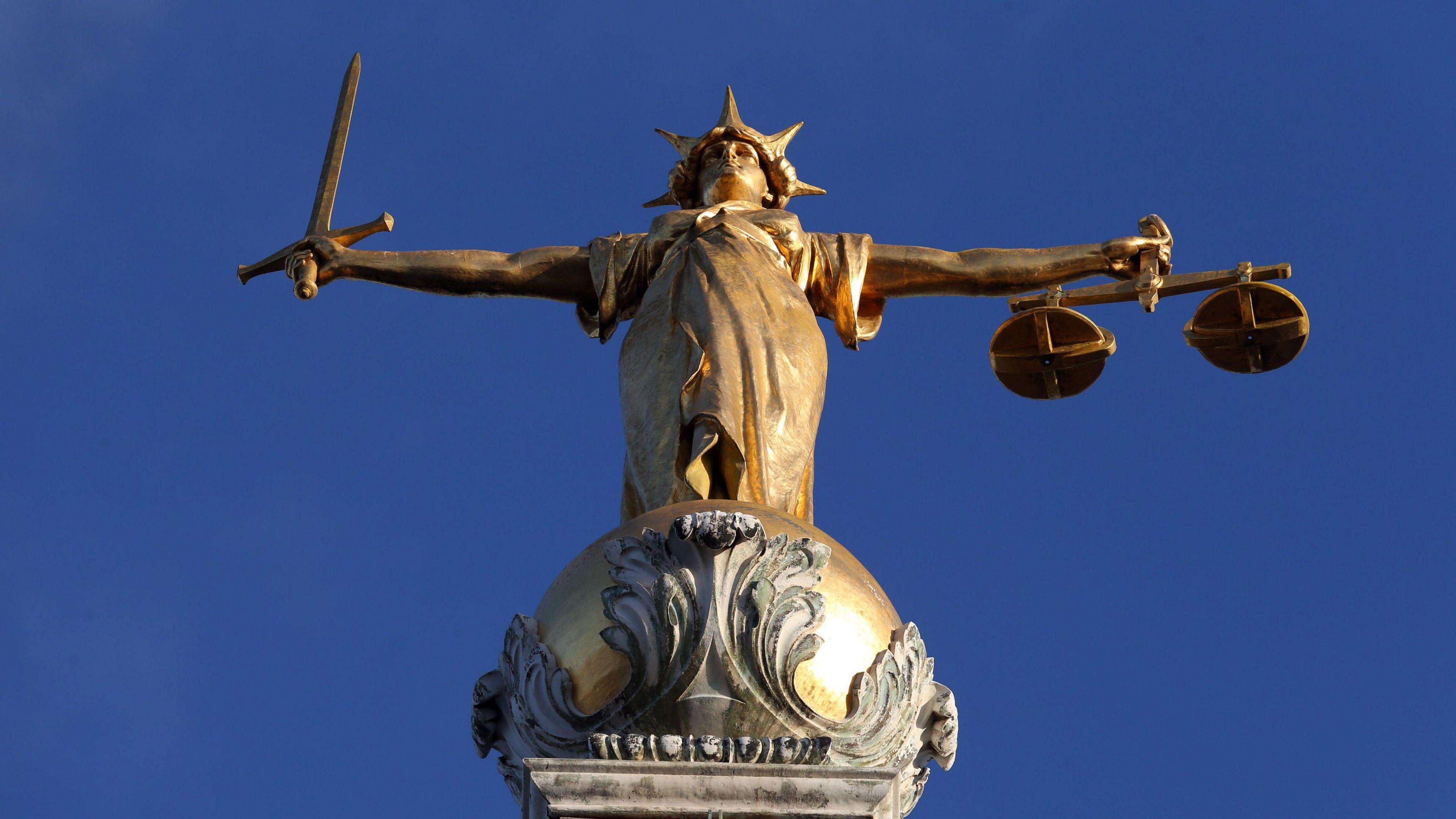 FW Pomeroy's Statue of Justice stands atop the Central Criminal Court building, Old Bailey, London.