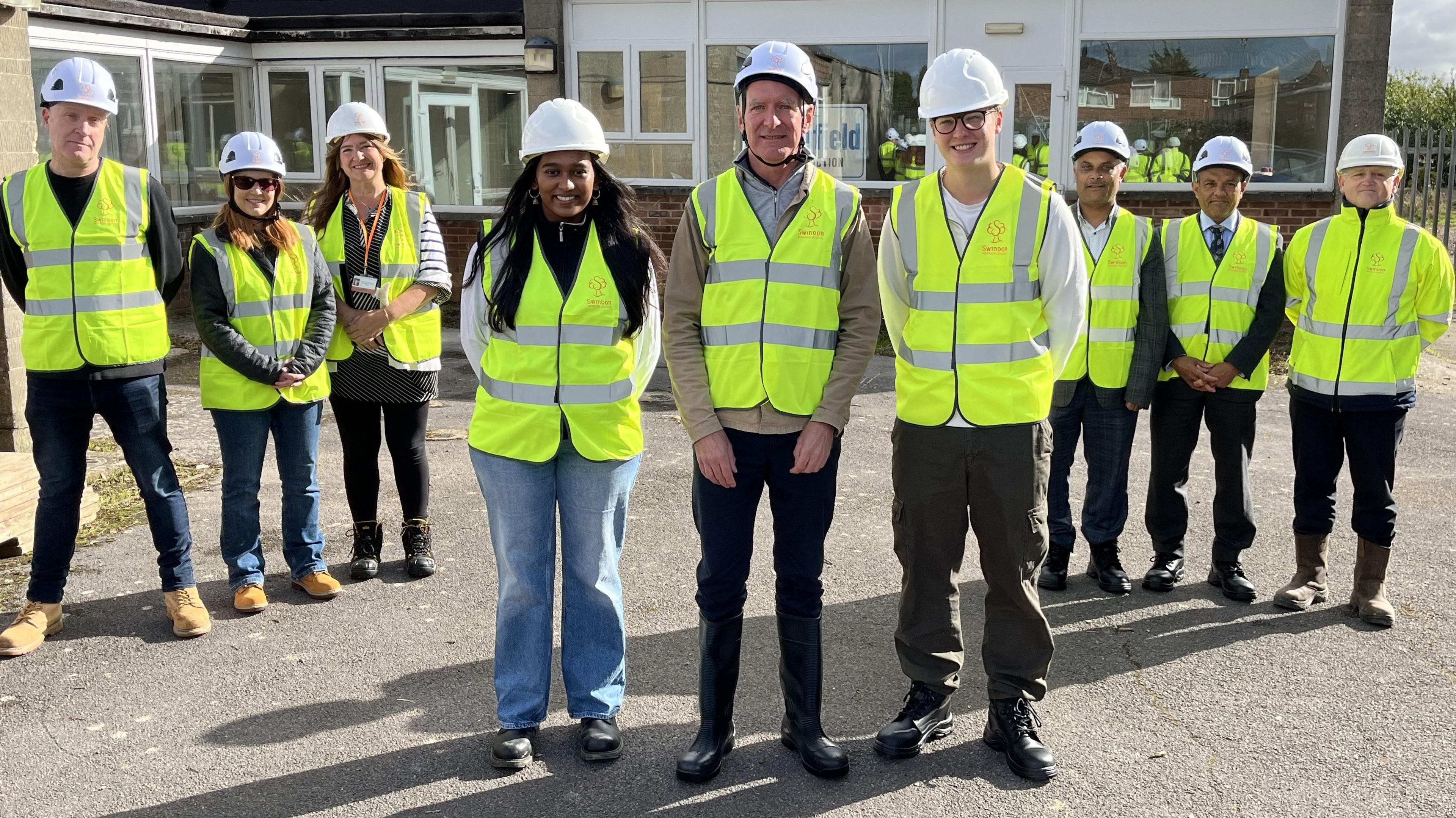 Nine key people from the project, including representatives of Swindon Borough Council, WAY, STEP Swindon and smash youth project line up for the camera wearing high visability vests and white hard hats