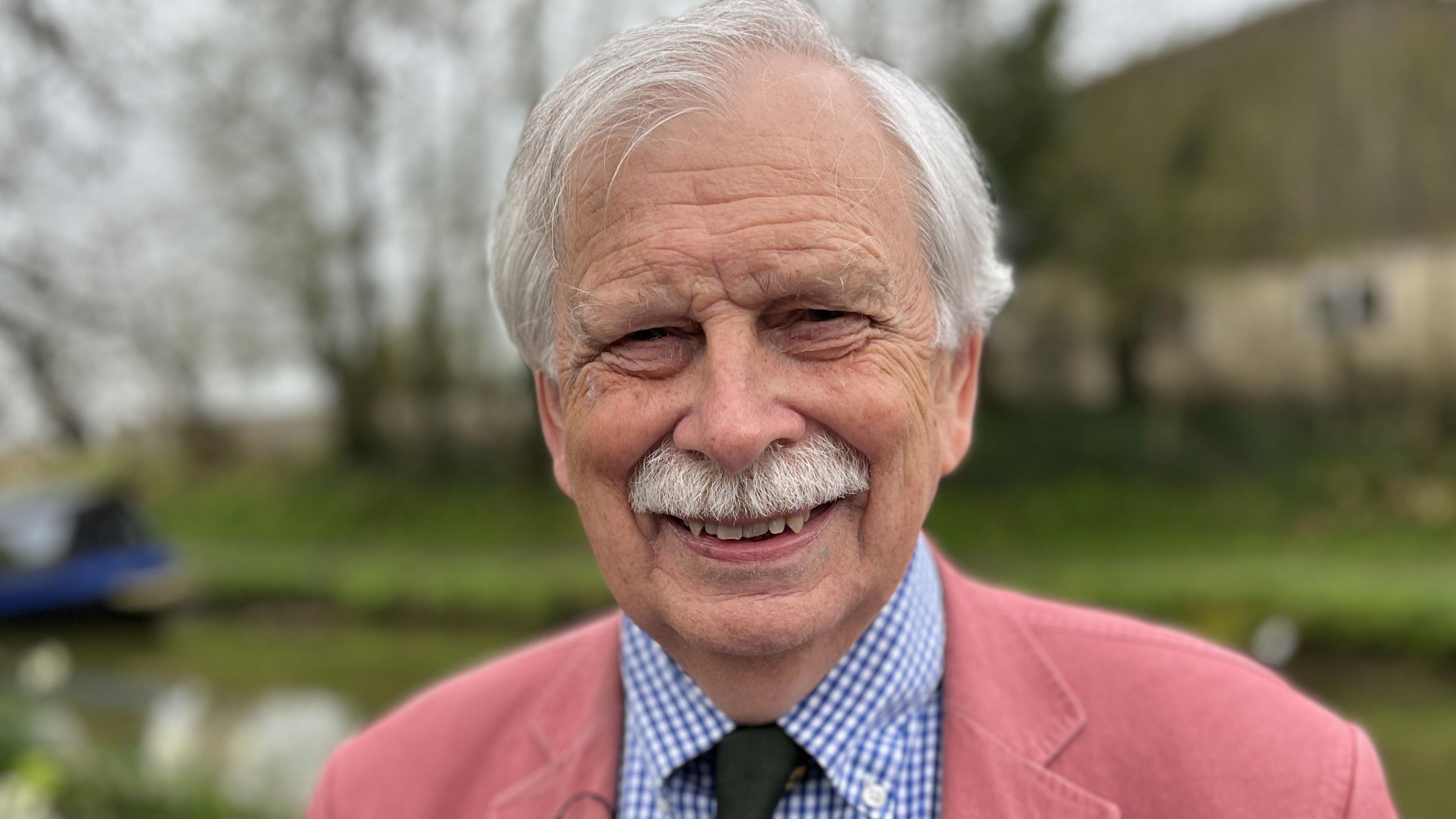 Councillor Ian Blair-Pilling smiling and standing on the edge of the canal