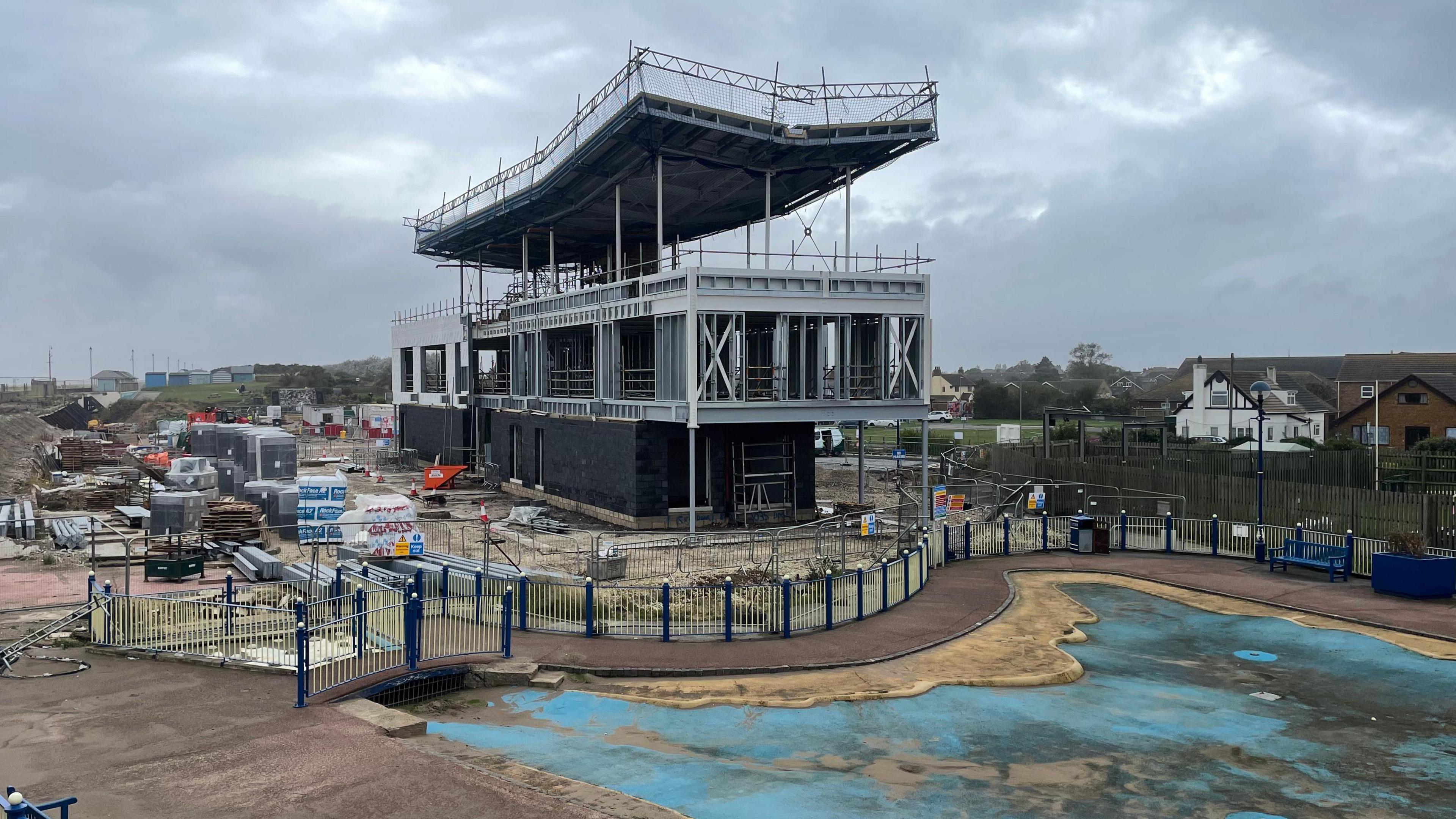 The new colonnade building under construction showing a metal three storey structure 