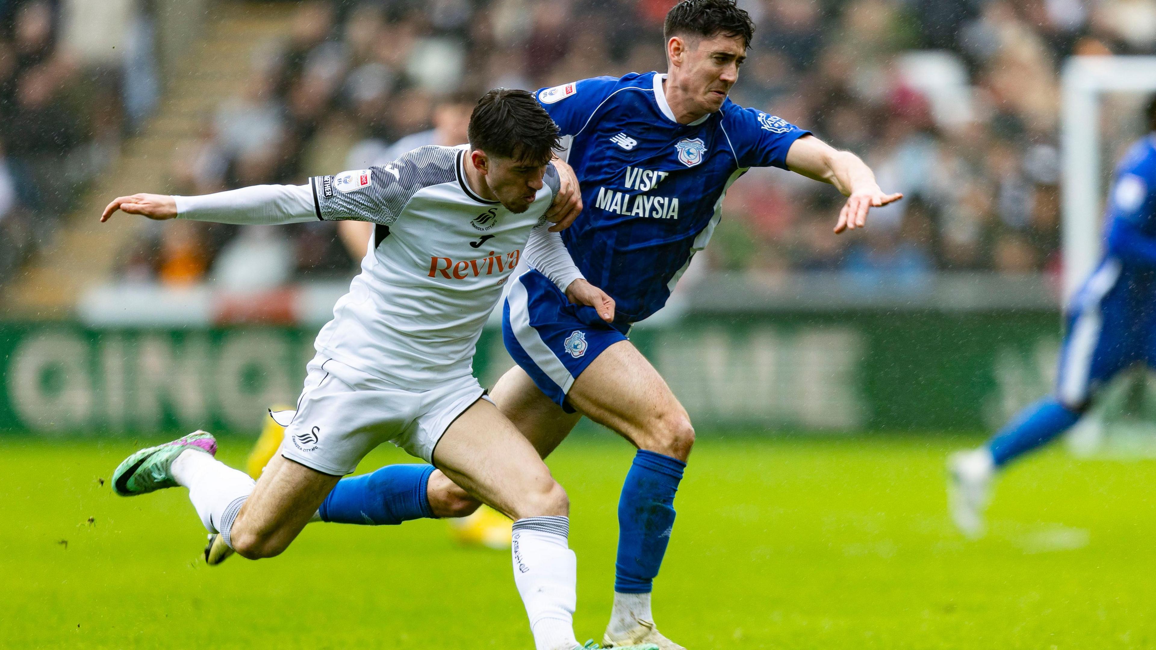 Josh Key of Swansea City in action against Callum O'Dowda of Cardiff City