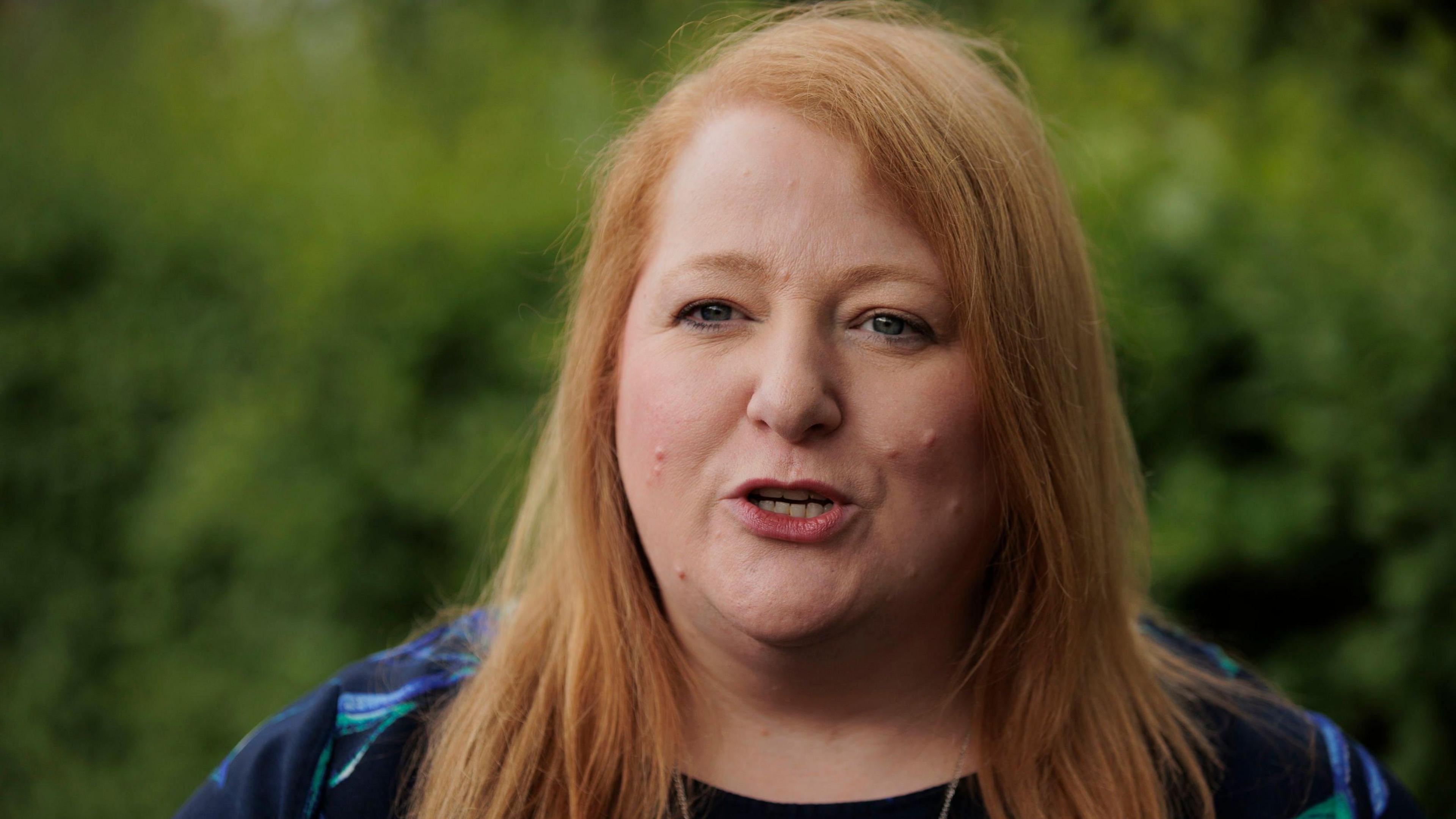 Justice Minister Naomi Long looking into the camera