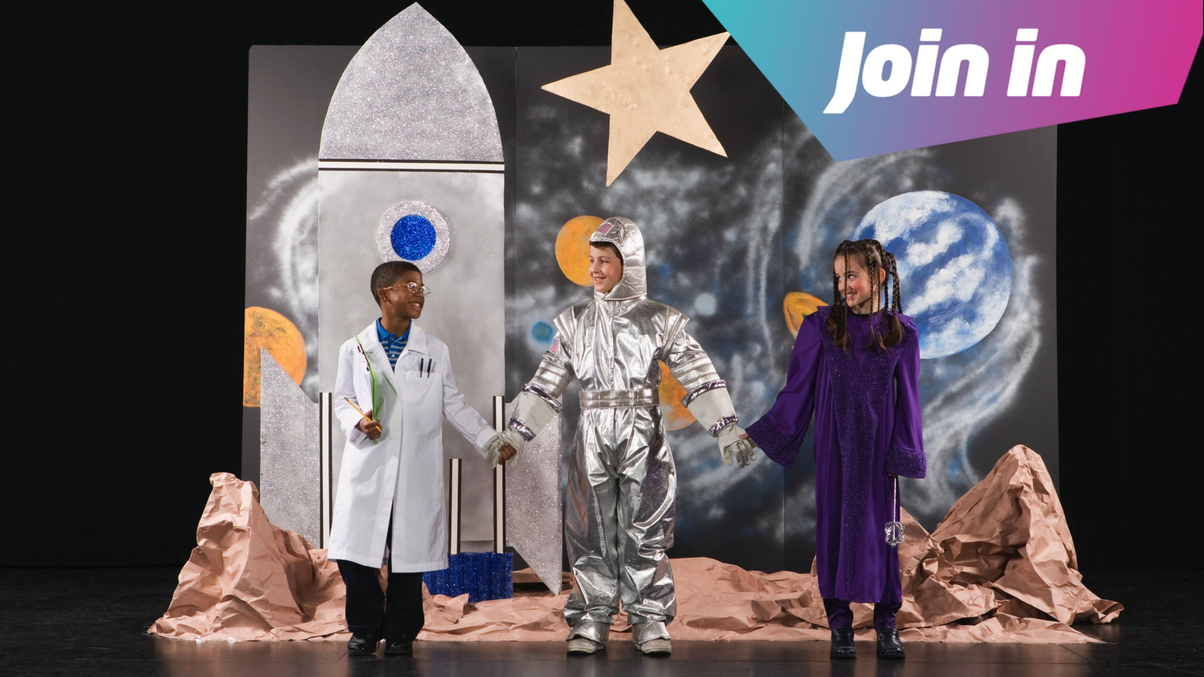A school stage with pupils dressed as astronauts and scientists.