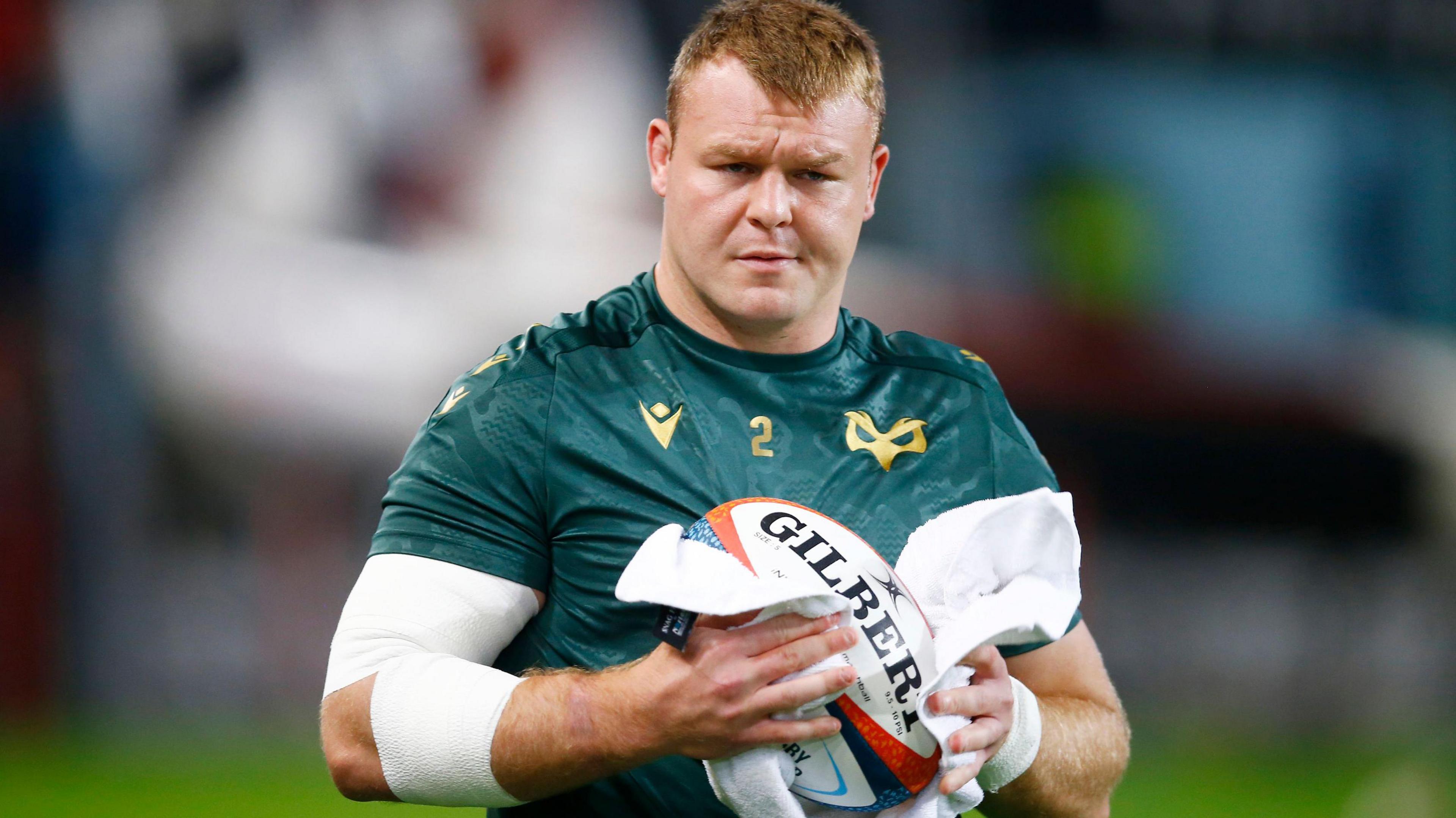 Dewi Lake wiping a rugby ball