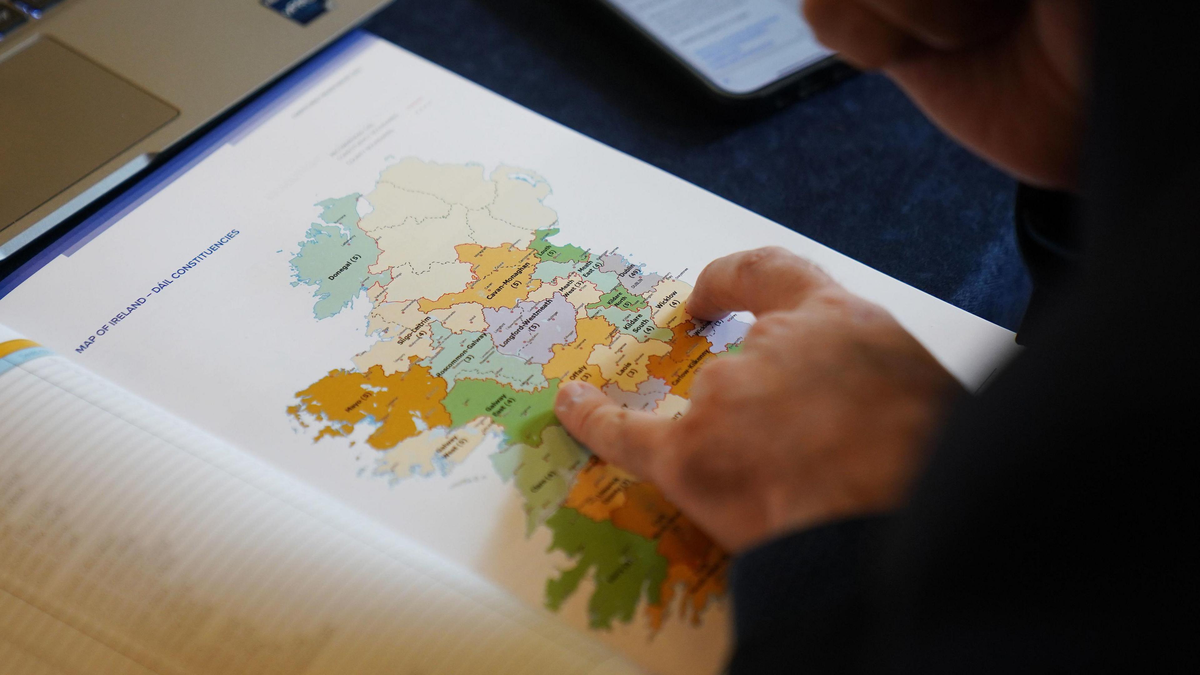 A journalist looks at a map of Ireland showing Dail Constituencies during a press confrence at the Royal College of Physicians, Dublin, for the Electoral Commission announcement of the much-anticipated new constituency boundaries for Ireland, 