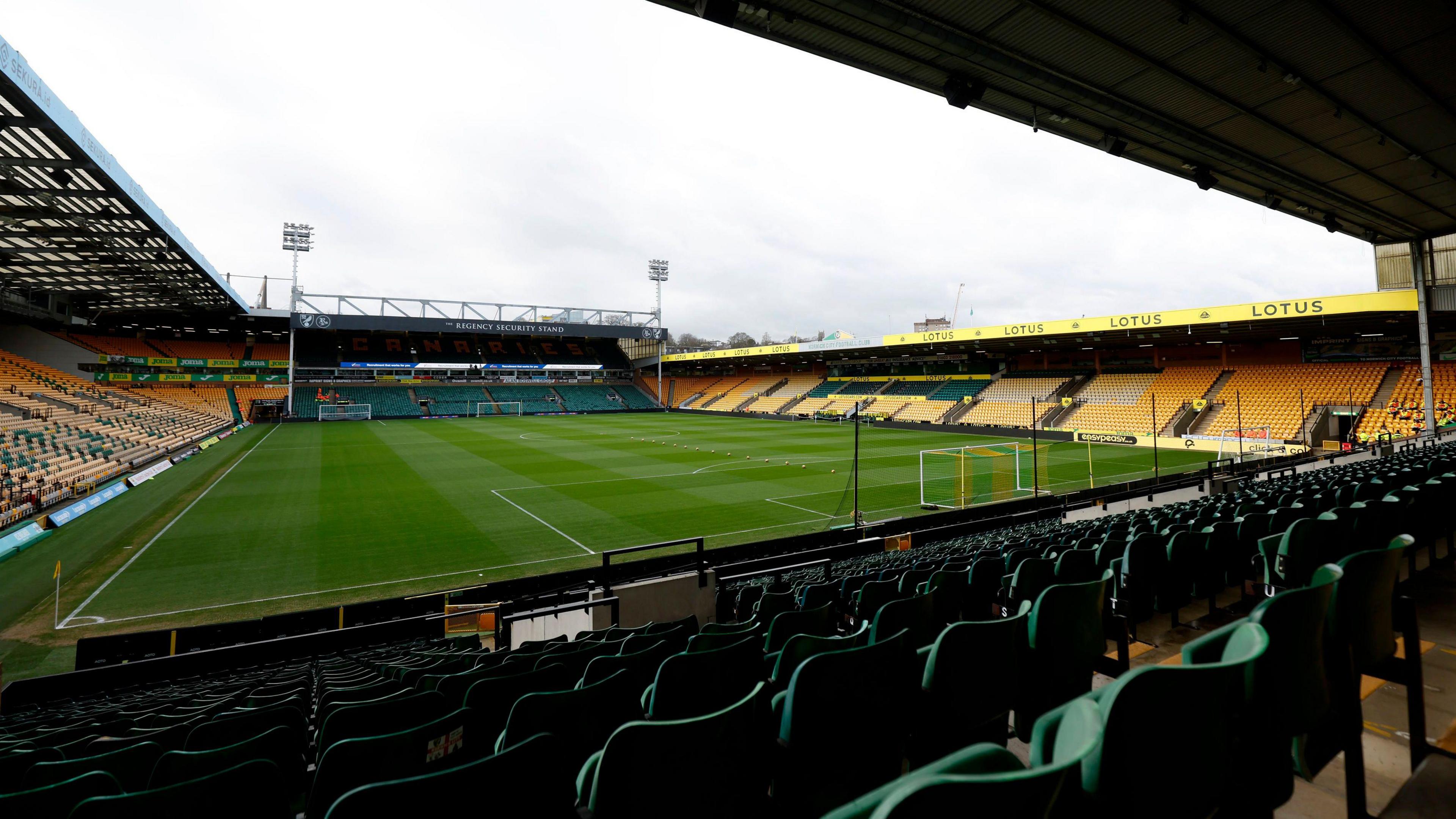 The inside of Carrow Road football stadium in Norwich with empty stands for fans.