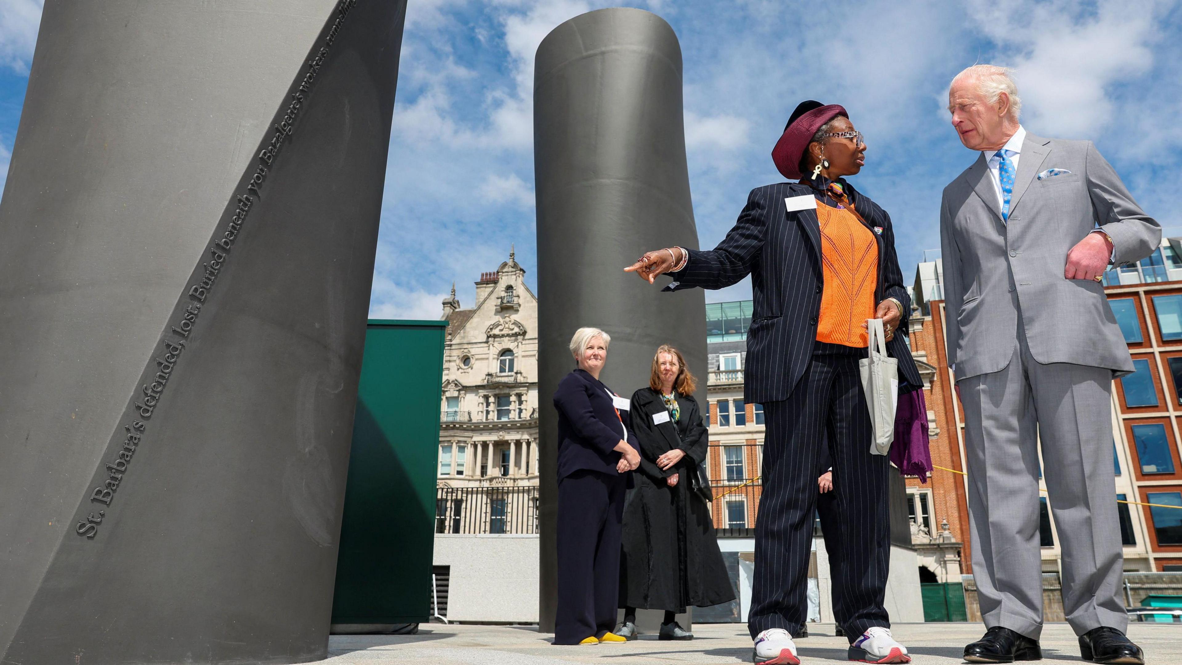 King Charles III speaks with a poet Dorothea Smartt, whose poetry about the Thames is printed on the ventilation columns