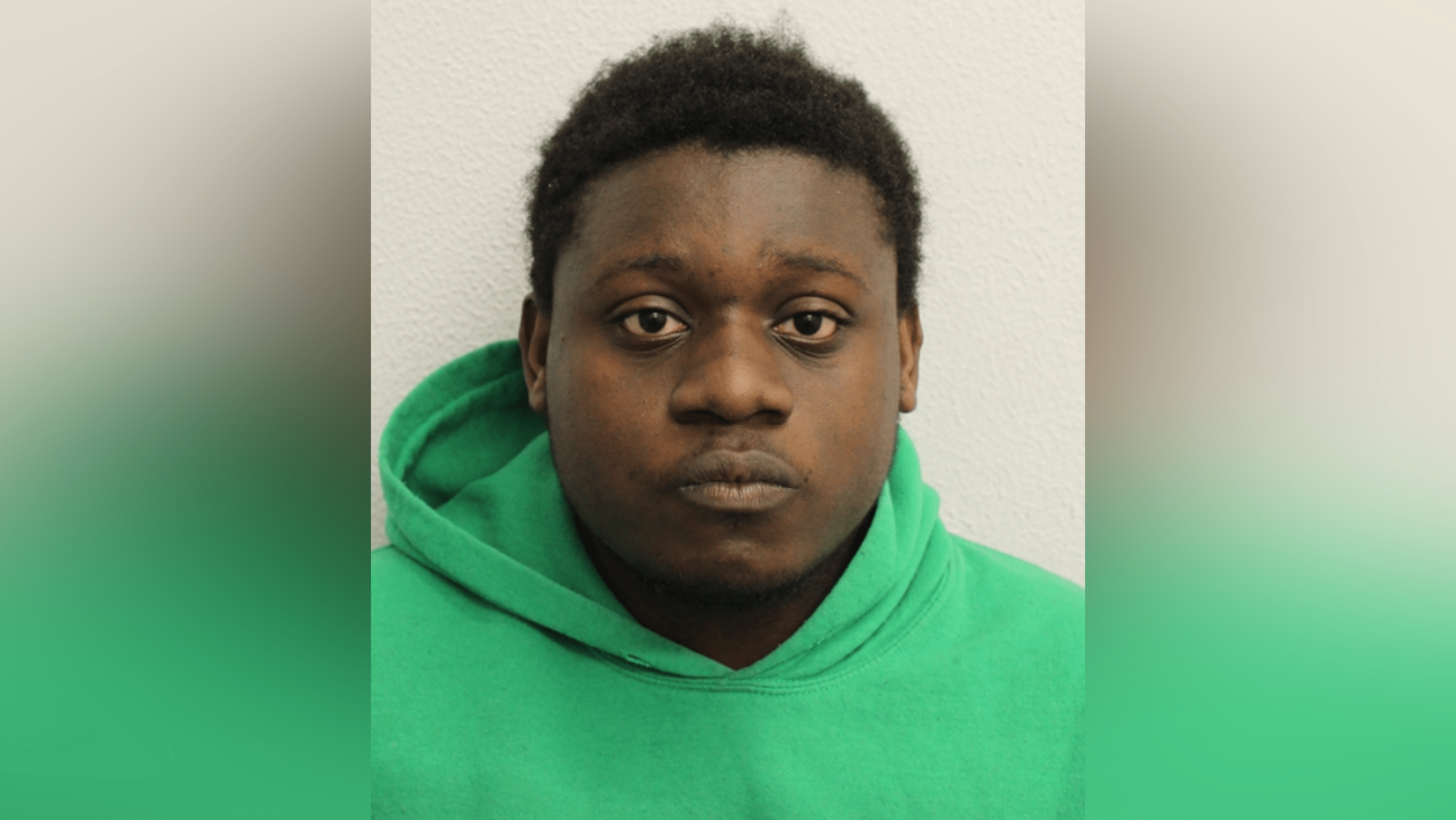 A custody image of Barthimaus Ehiemere in a green hoodie.