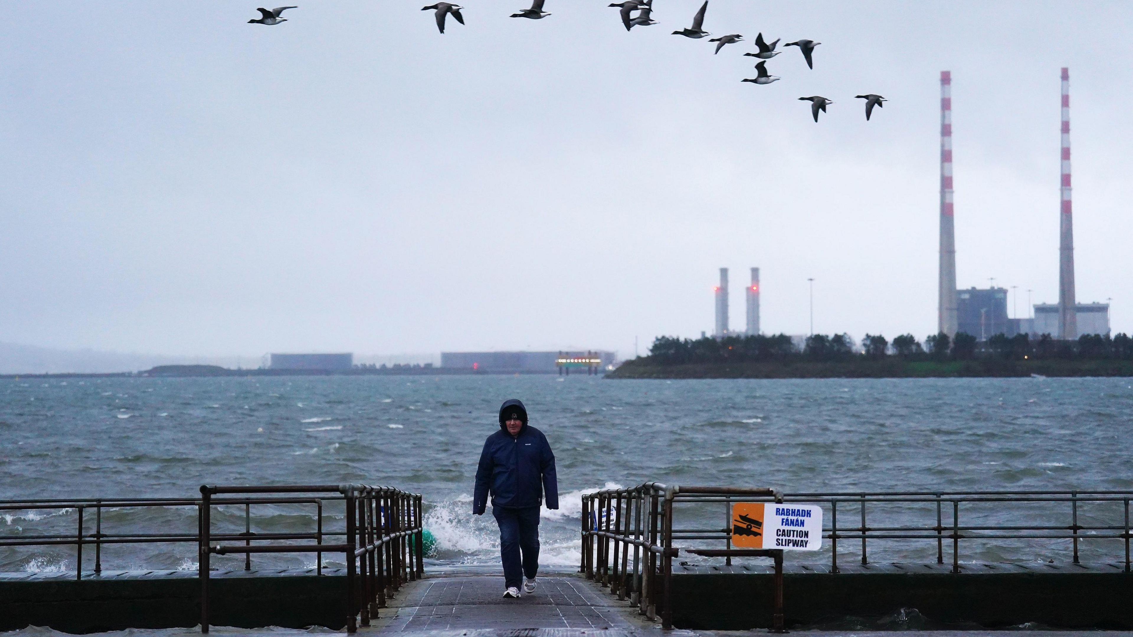 A person on a slipway in Clontarf, Dublin. Storm Darragh is approaching the UK and Ireland and is expected to bring winds of up to 80mph and heavy rain on Friday and into the weekend. Picture date: Friday December 6, 2024