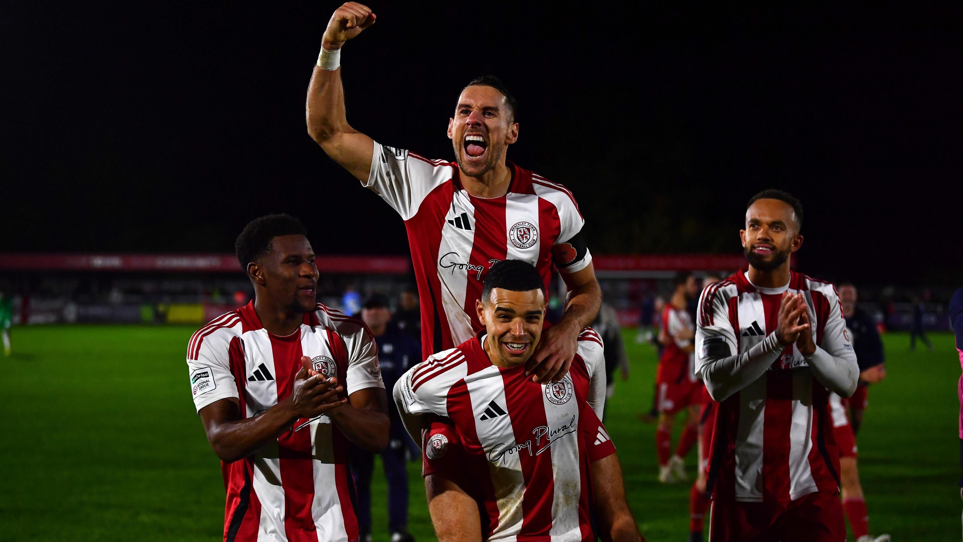 Brackley Town players celebrate beating Notts County in the FA Cup third round