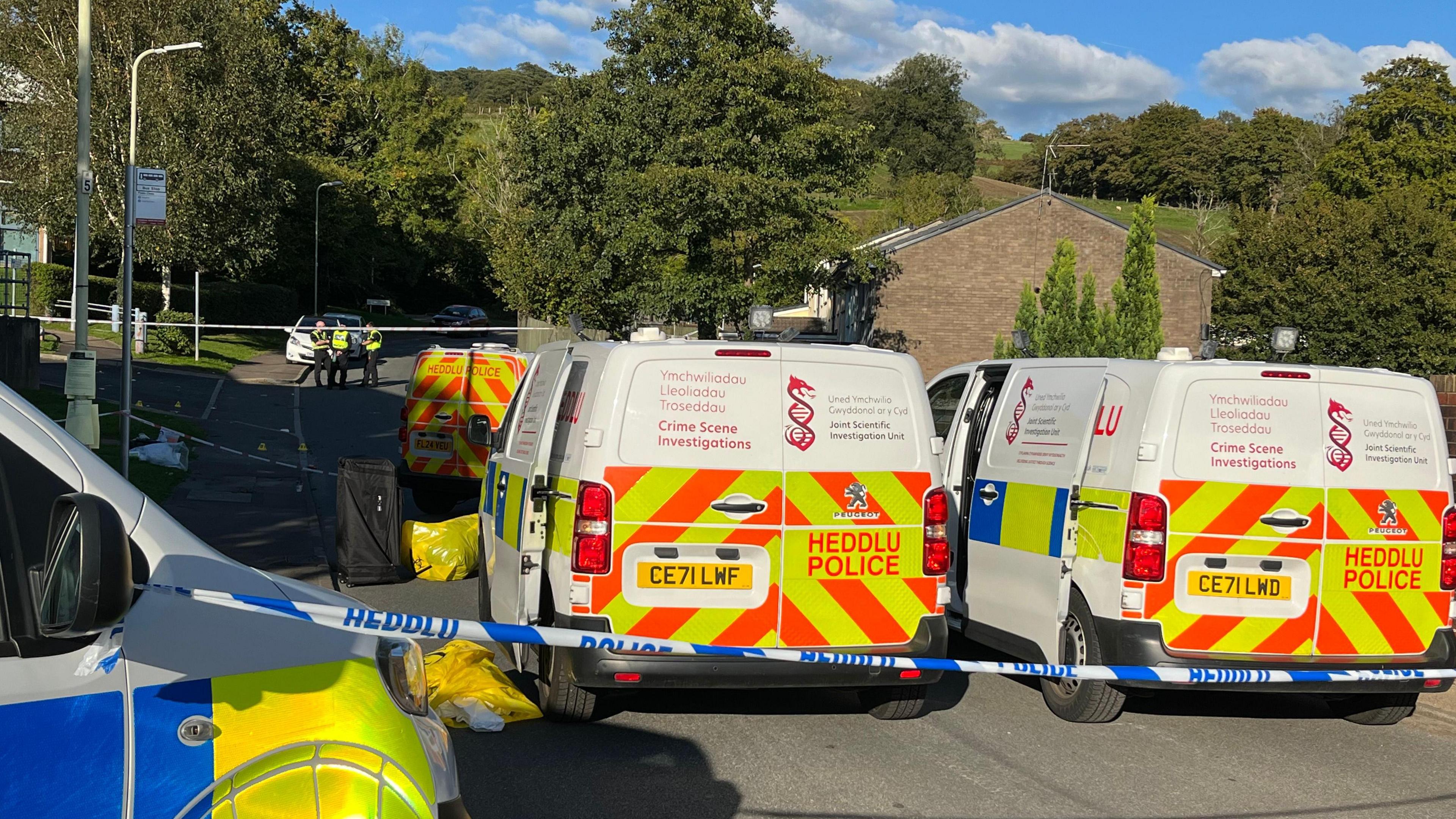 Four police vehicles and a police cordon