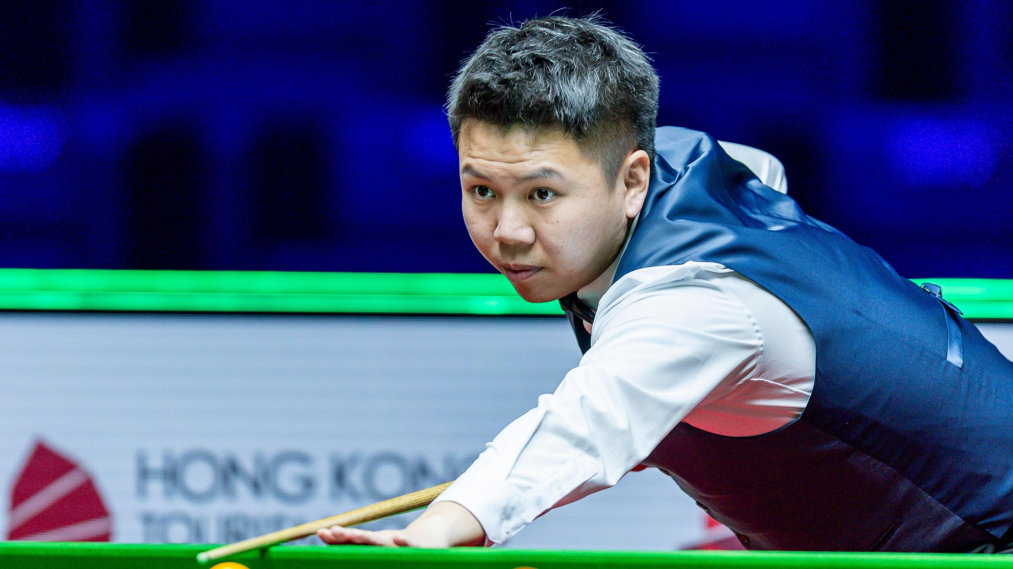 China's Zhou Yuelong prepares to play a shot against Ali Carter in their World Grand Prix quarter-final in Hong Kong
