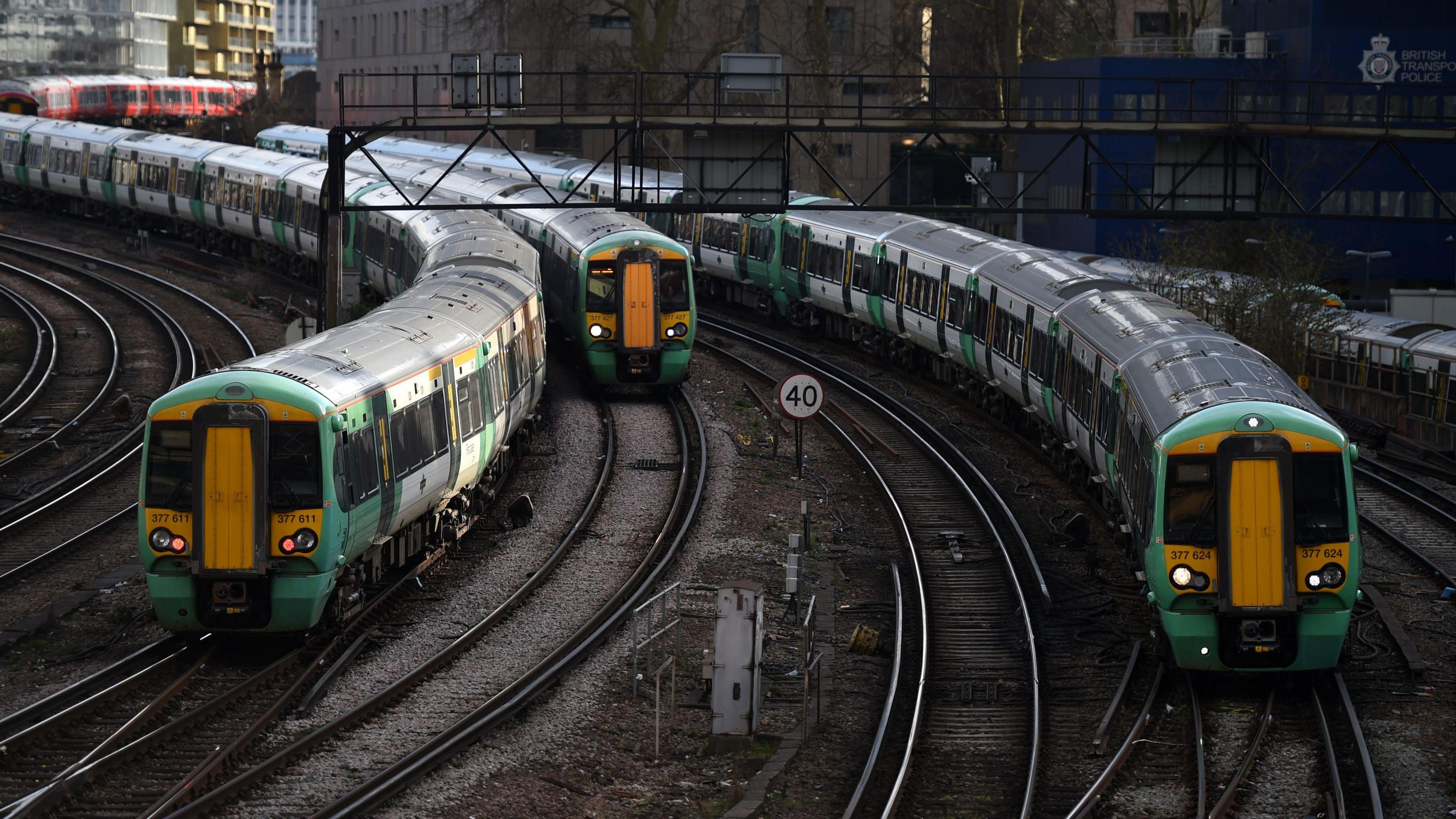 Three Southern trains moving, one towards the camera and the other away from it