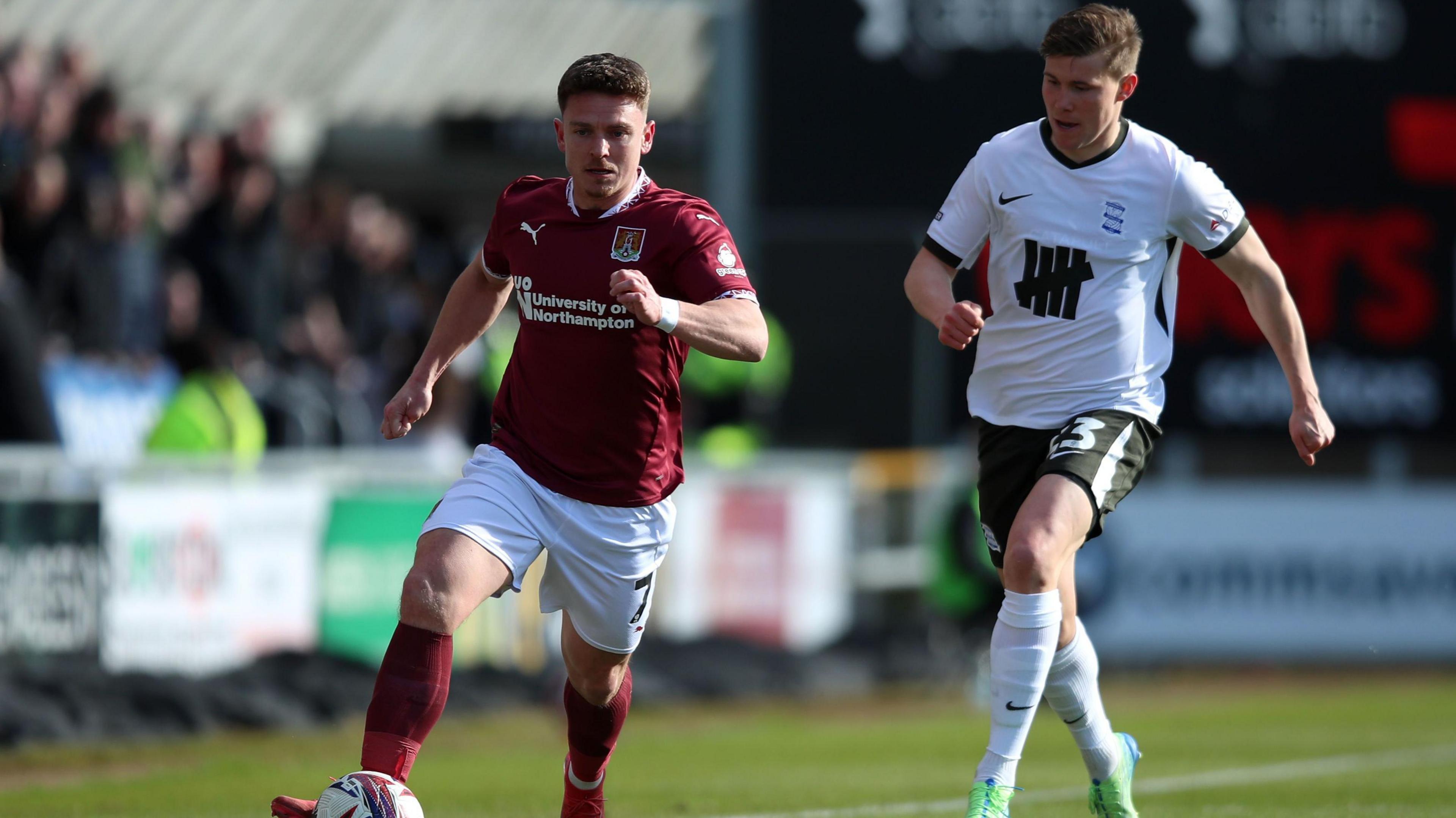 Northampton Town's Sam Hoskins battles for the ball against Birmingham's Alfons Sampsted during the Sky Bet League One match at Sixfields Stadium, Northampton