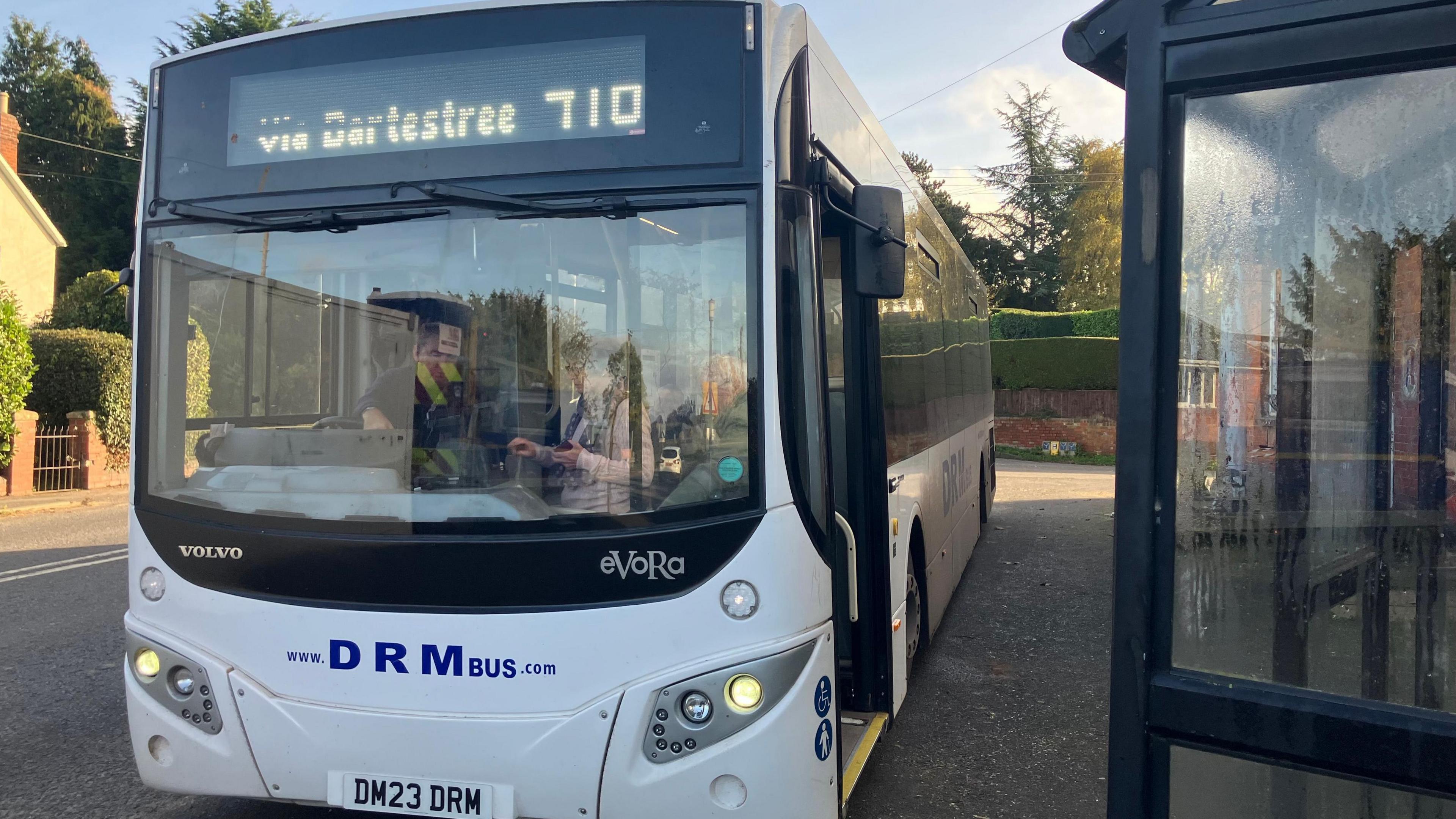 A white DRM bus pictured at a stop in Herefordshire, the company runs the service used by Janette and Doreen