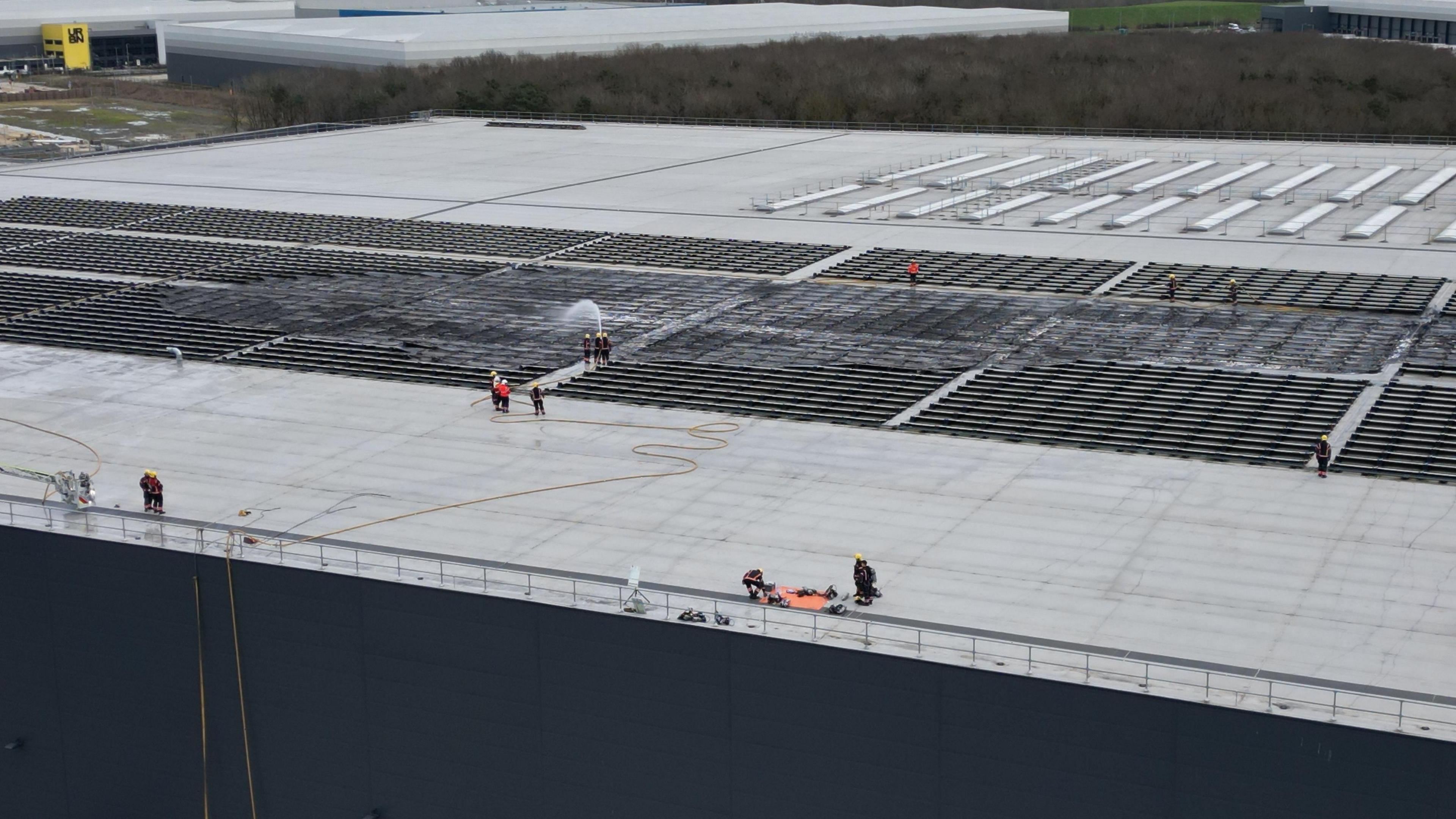 Firefighters on the roof of a Lidl warehouse