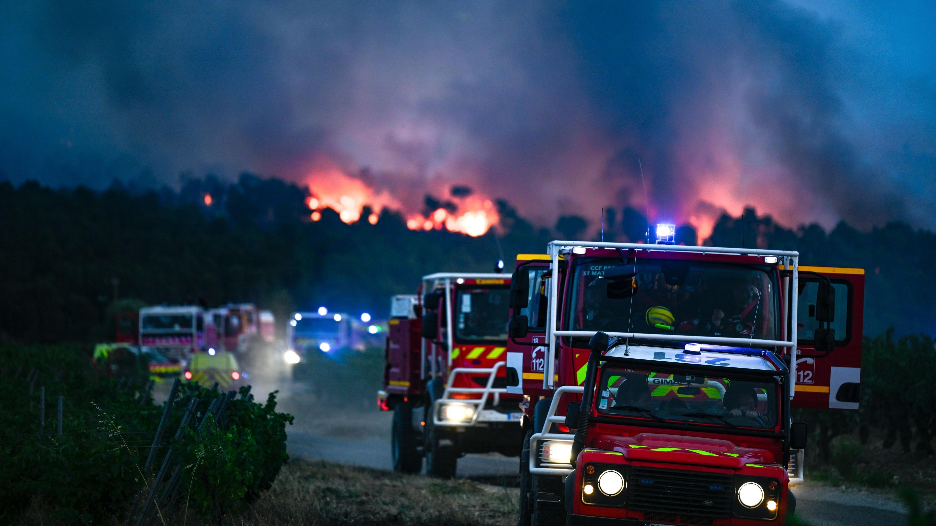Firefighting crews are deployed to battle a forest fire in Saint-Laurent-de-la-Cabrerisse.
